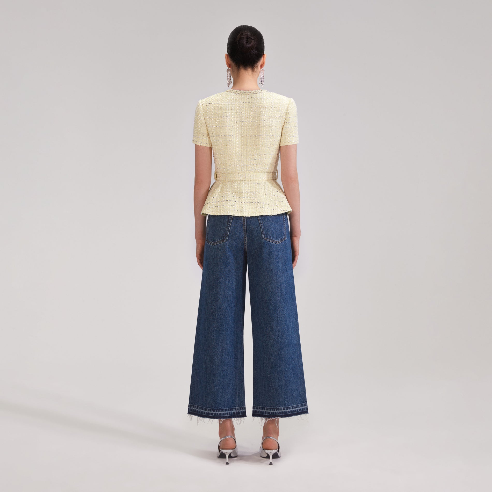 A woman wearing the Yellow Boucle Top