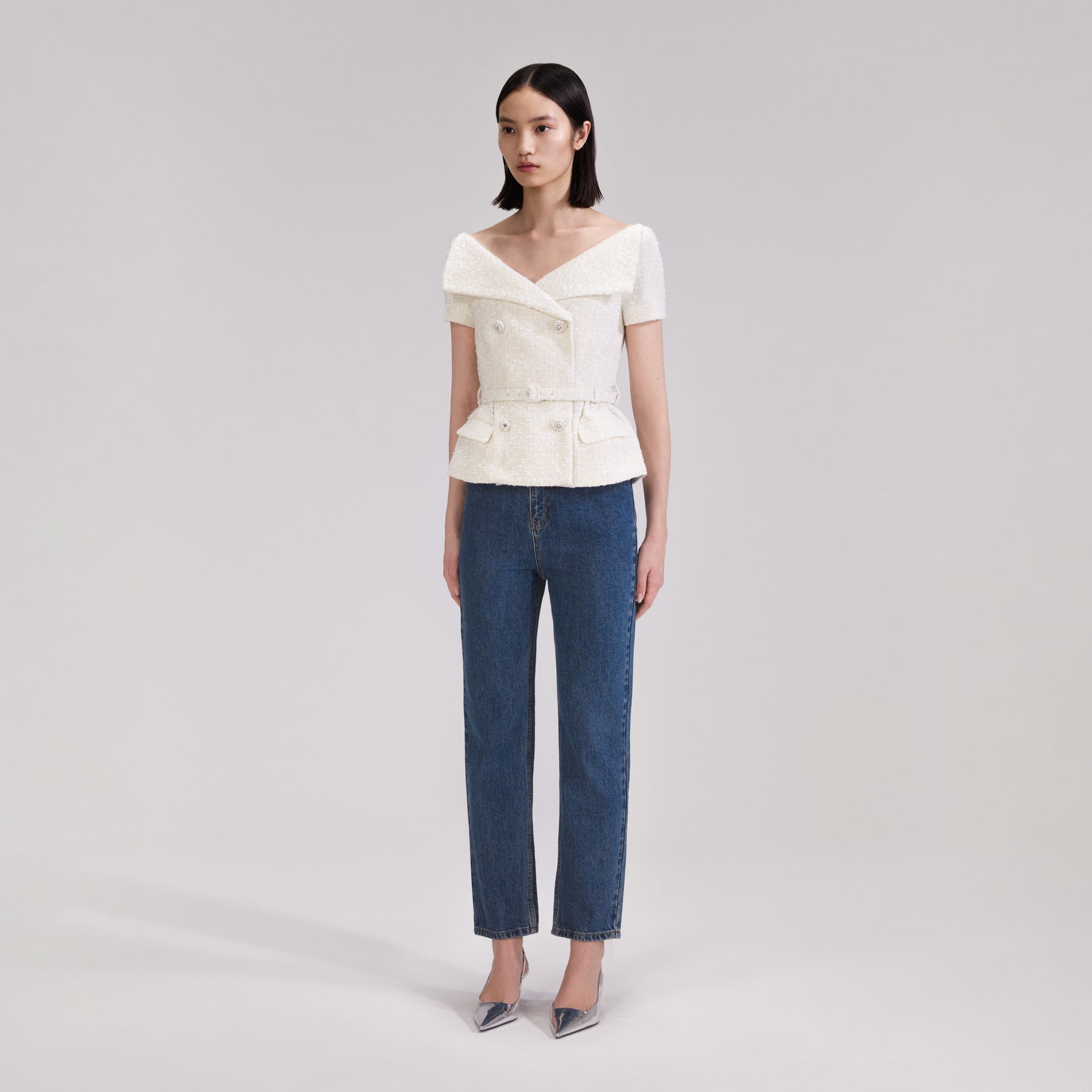 A woman wearing the Cream Off Shoulder Boucle Top