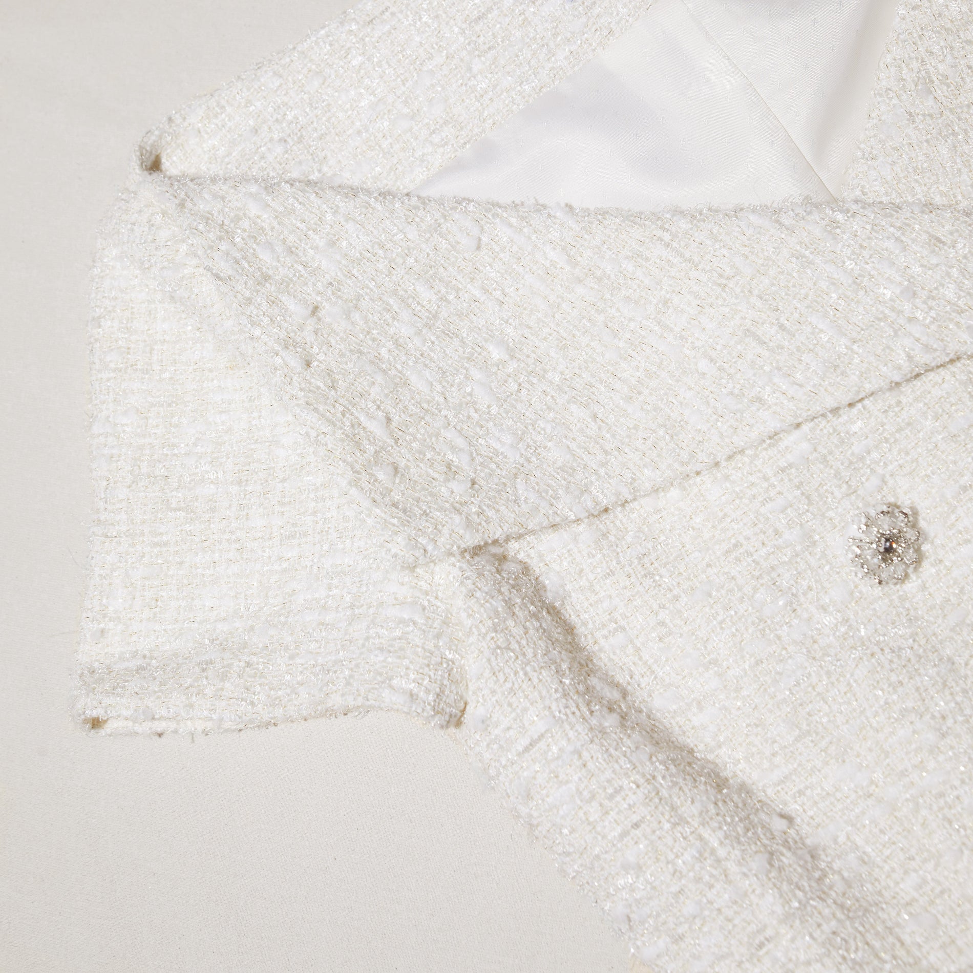 A close up of the fabric for the Cream Off Shoulder Boucle Top