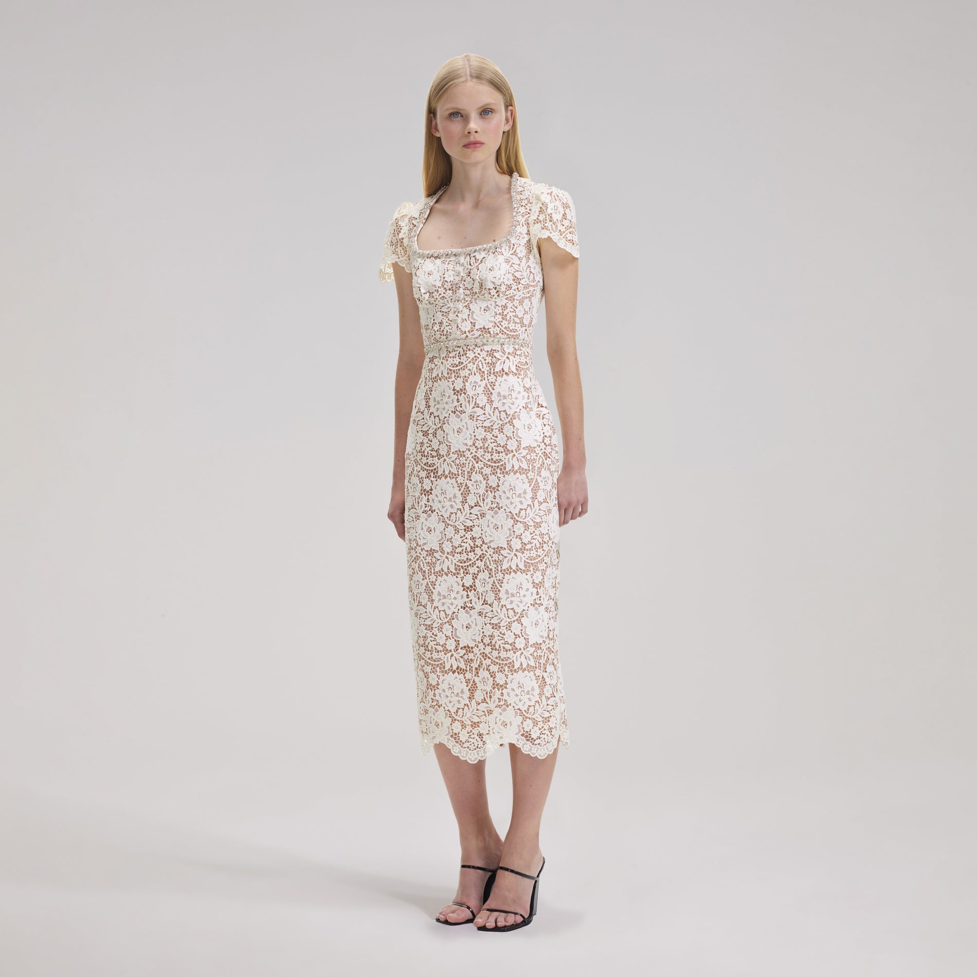 A woman wearing the Cream Cord Lace Diamante Midi Dress