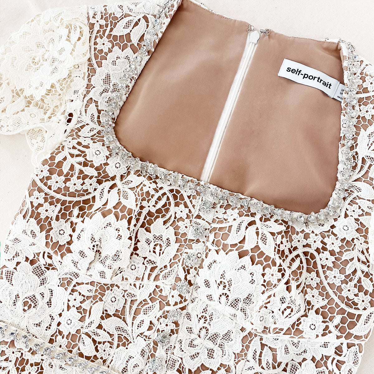 A close up of the fabric for the Cream Cord Lace Diamante Midi Dress