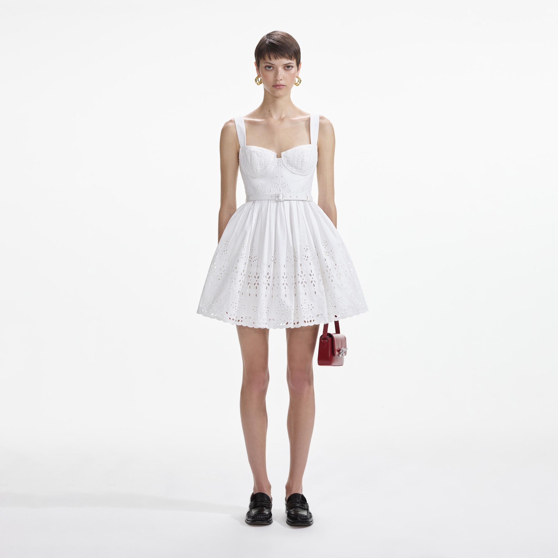 Front view of a woman wearing the White Cotton Broderie Mini Dress