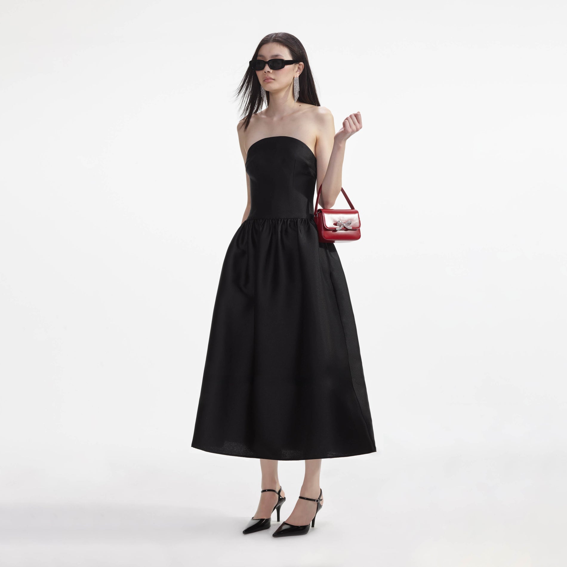 Side view of a woman wearing the Black Taffeta Midi Dress