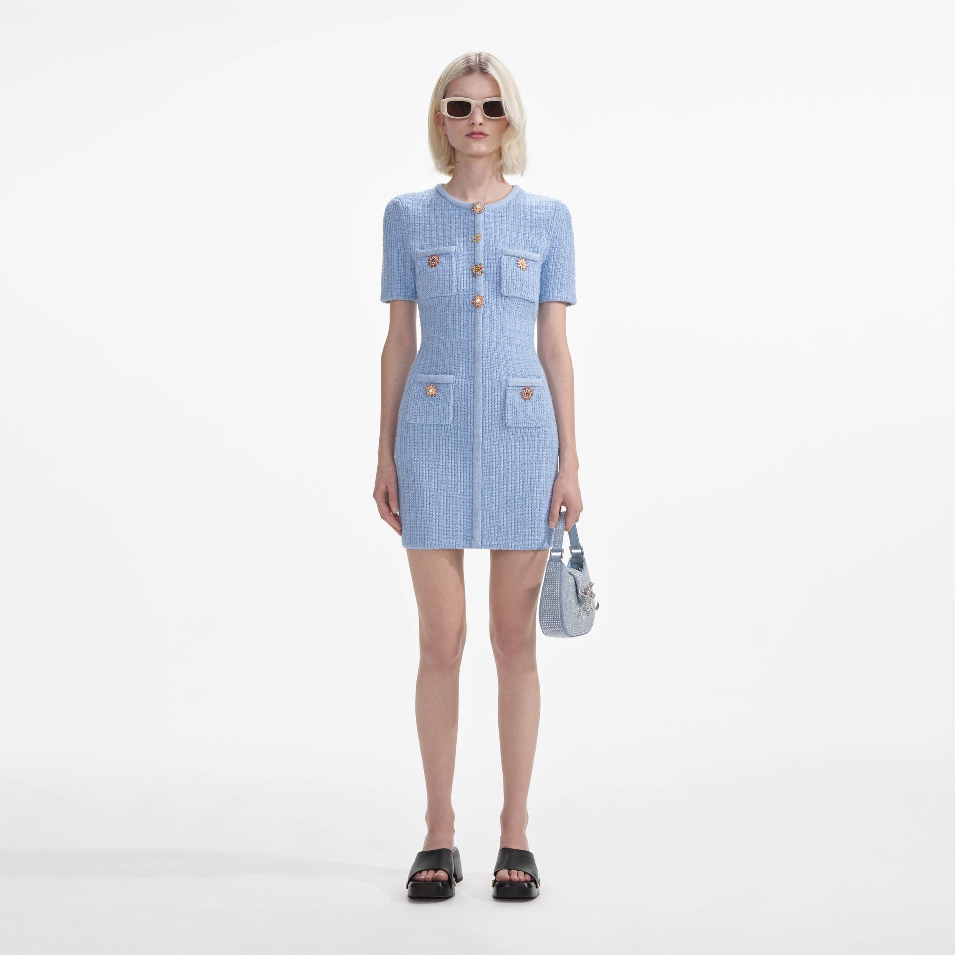 Front view of a woman wearing the Blue Jewel Button Knit Mini Dress
