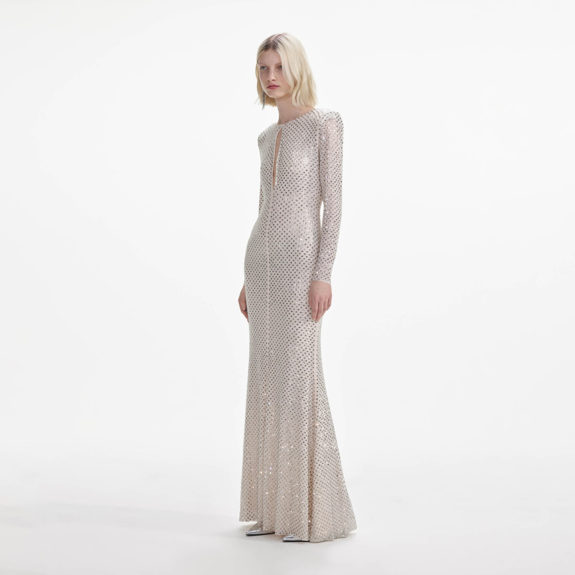 Side view of a woman wearing the Cream Rhinestone Keyhole Maxi Dress