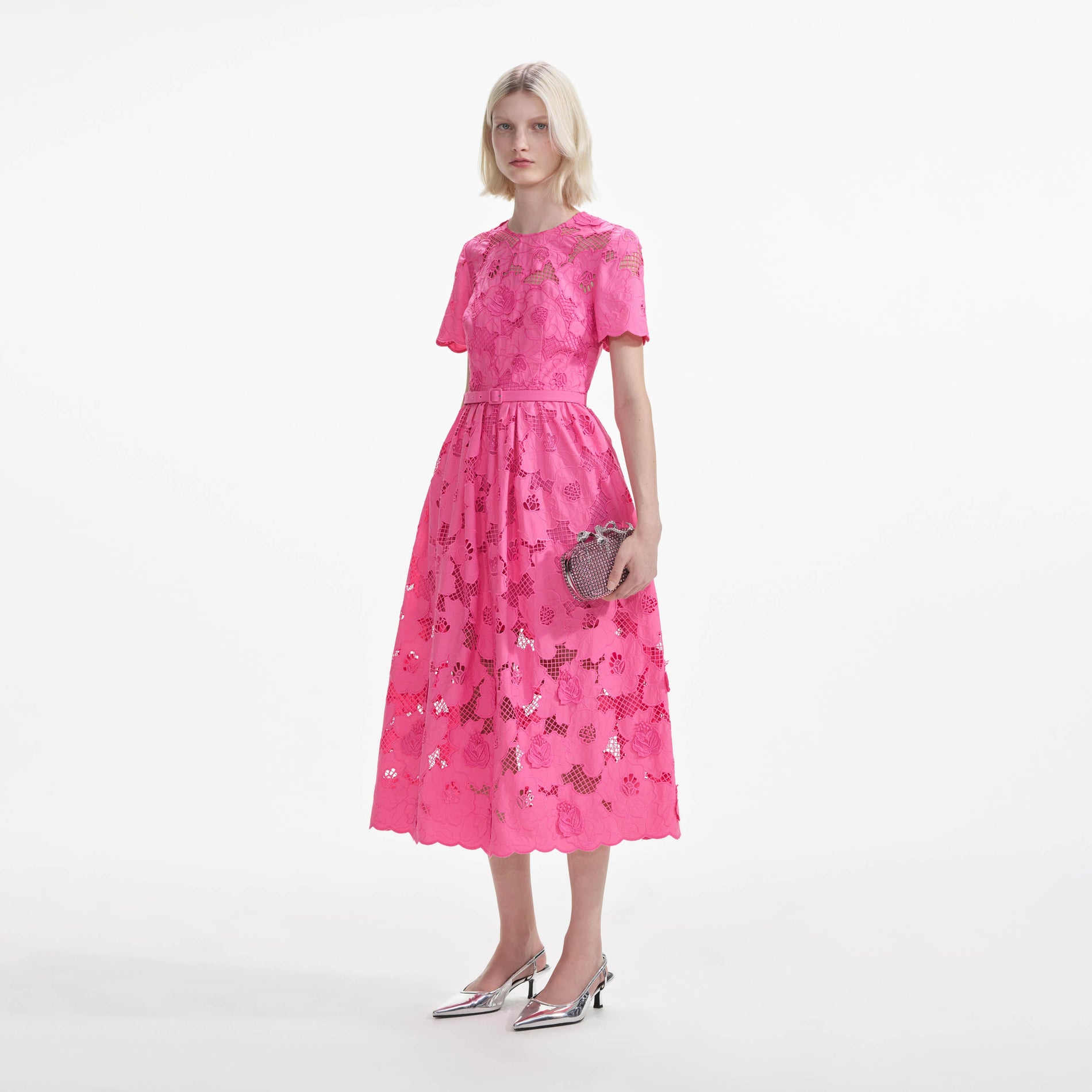 Side view of a woman wearing the Pink Cotton Lace Midi Dress
