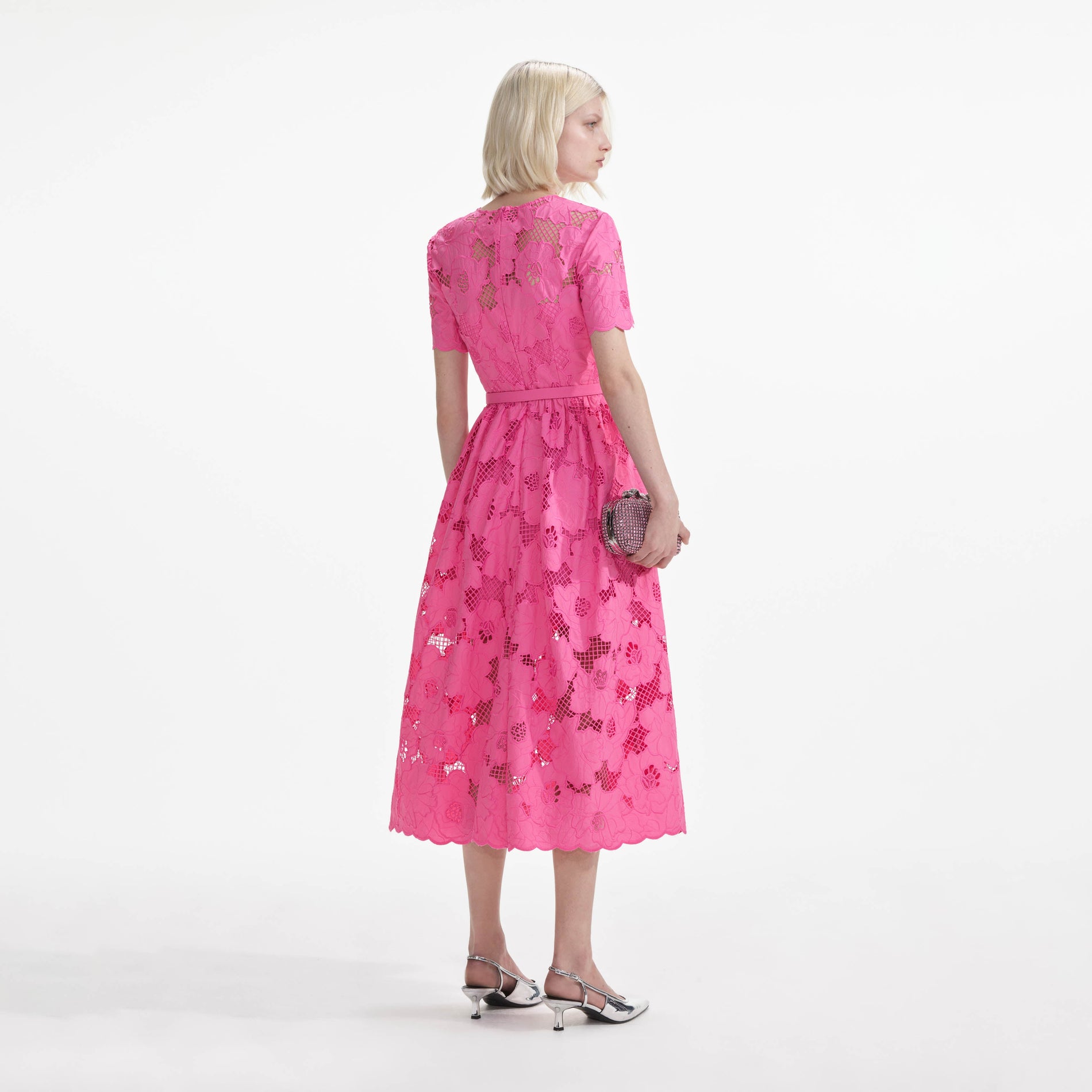 Back view of a woman wearing the Pink Cotton Lace Midi Dress