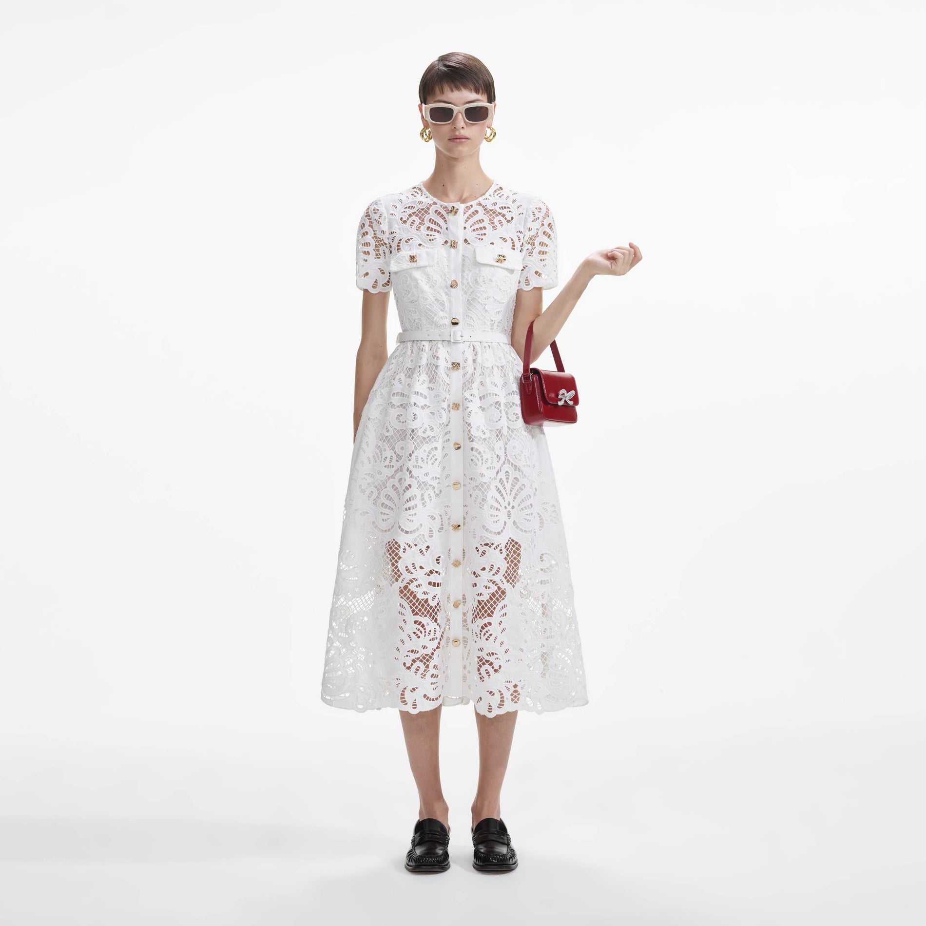 Front view of a woman wearing the White Cotton Lace Button Midi Dress
