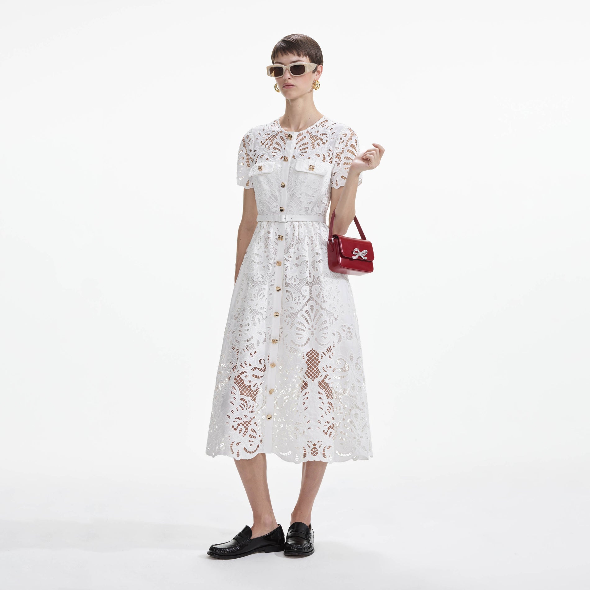 Side view of a woman wearing the White Cotton Lace Button Midi Dress