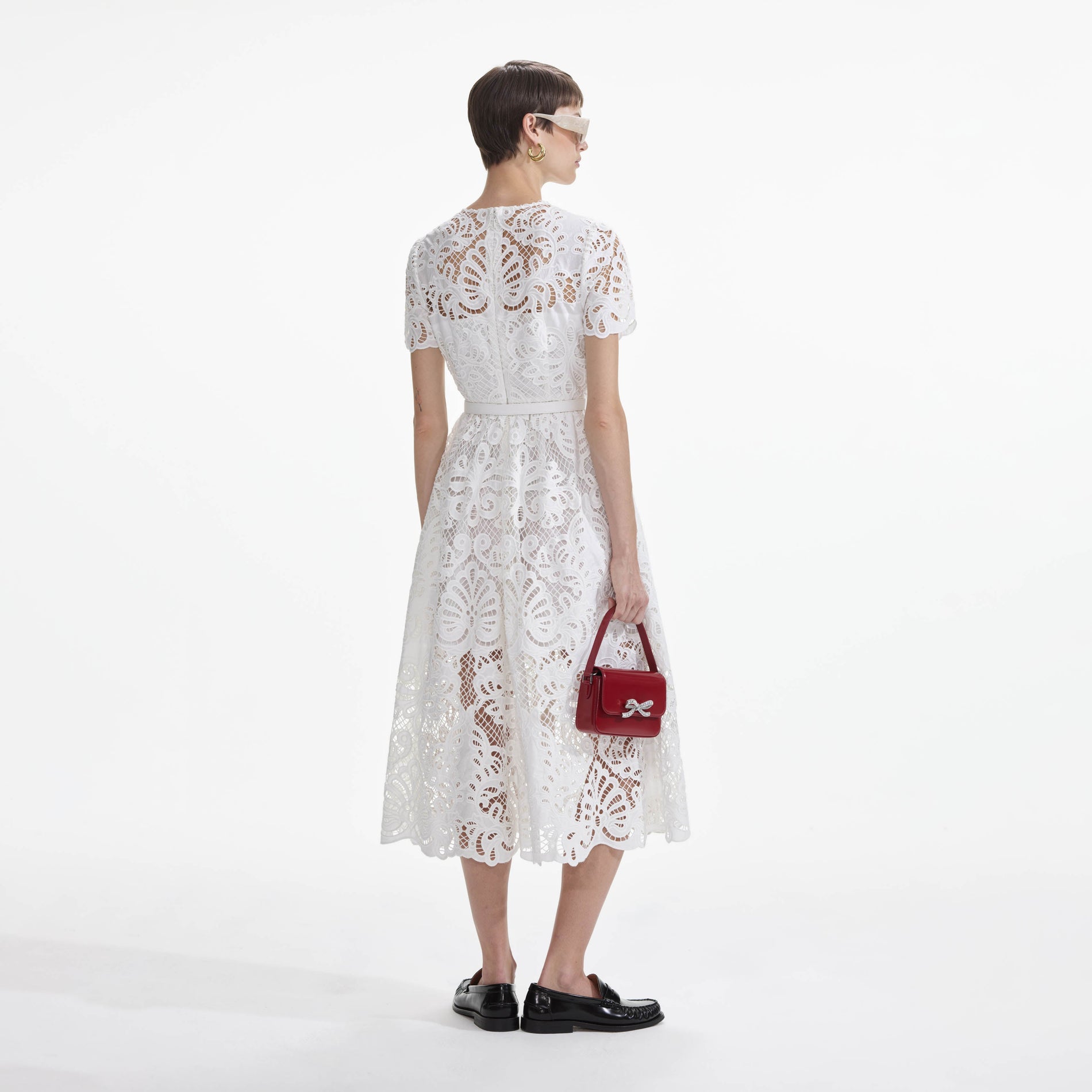 Back view of a woman wearing the White Cotton Lace Button Midi Dress