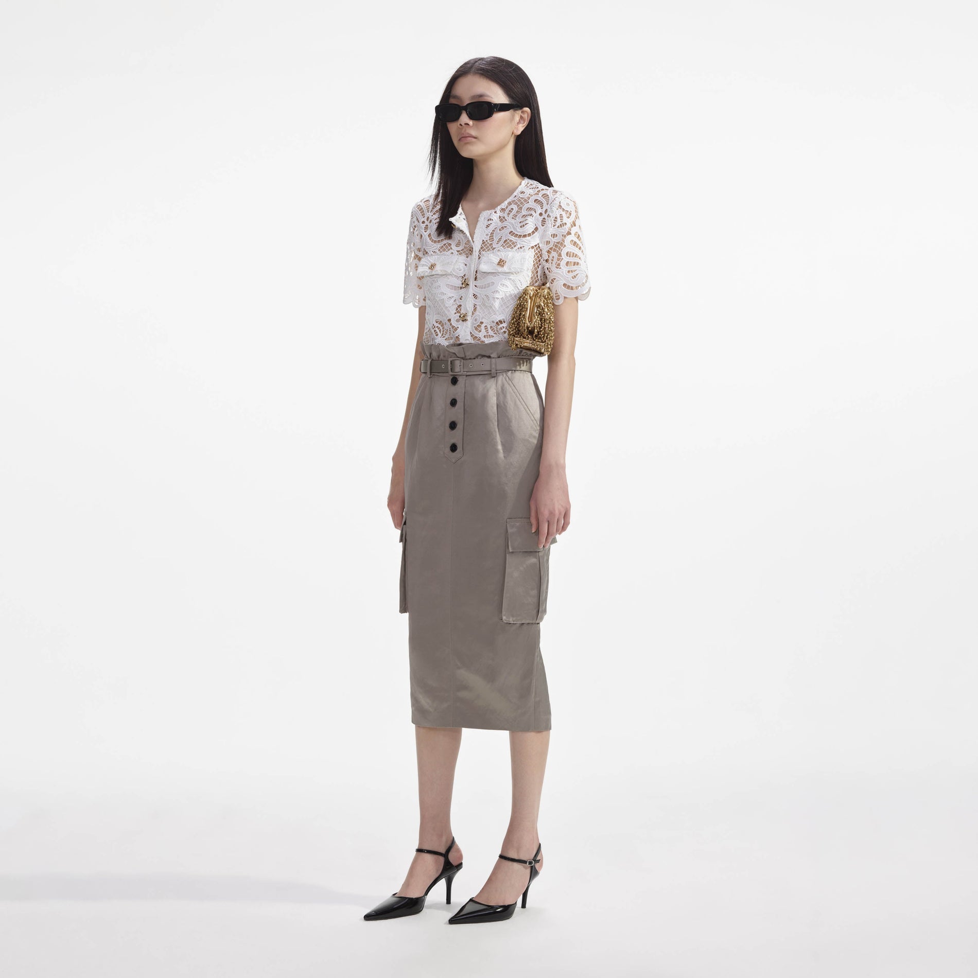 Side view of a woman wearing the White Guipure Lace Top