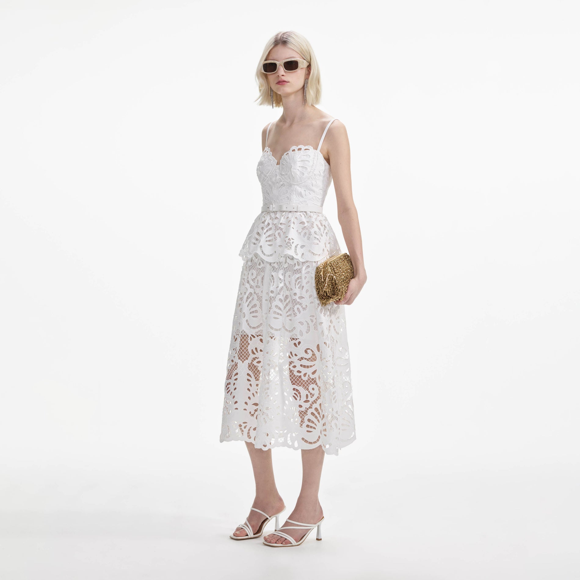 Side view of a woman wearing the White Cotton Lace Tiered Midi Dress