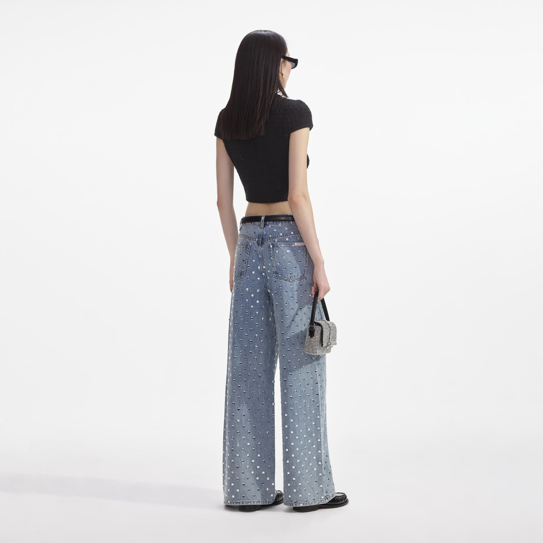 Back view of a woman wearing the Black Jewel Button Knit Top