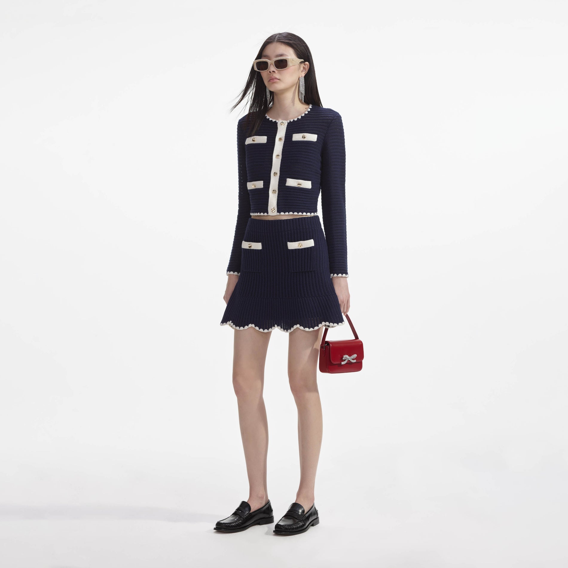 Side view of a woman wearing the Navy Crochet Contrast Trim Mini Skirt