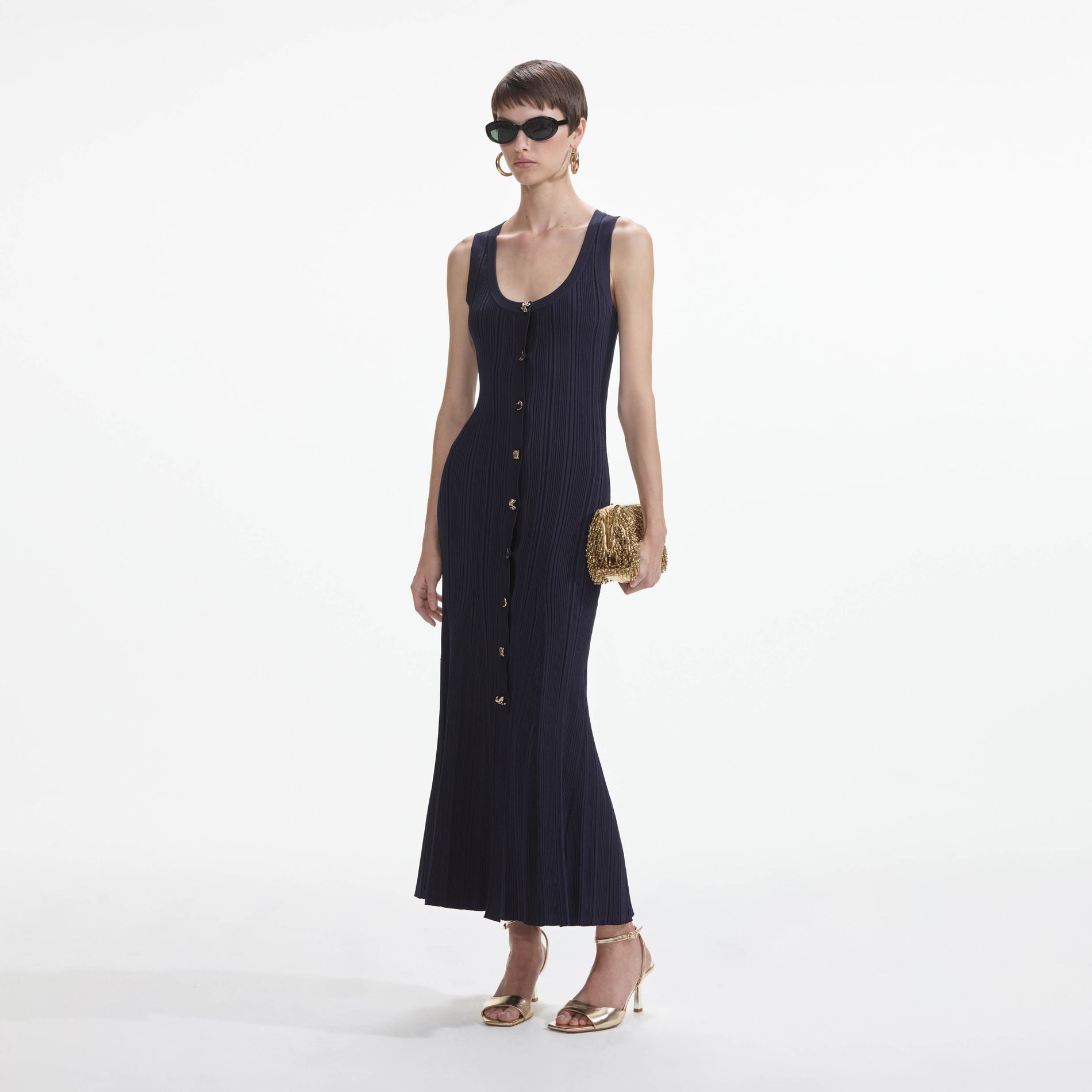 Side view of a woman wearing the Navy Viscose Knit Midi Dress