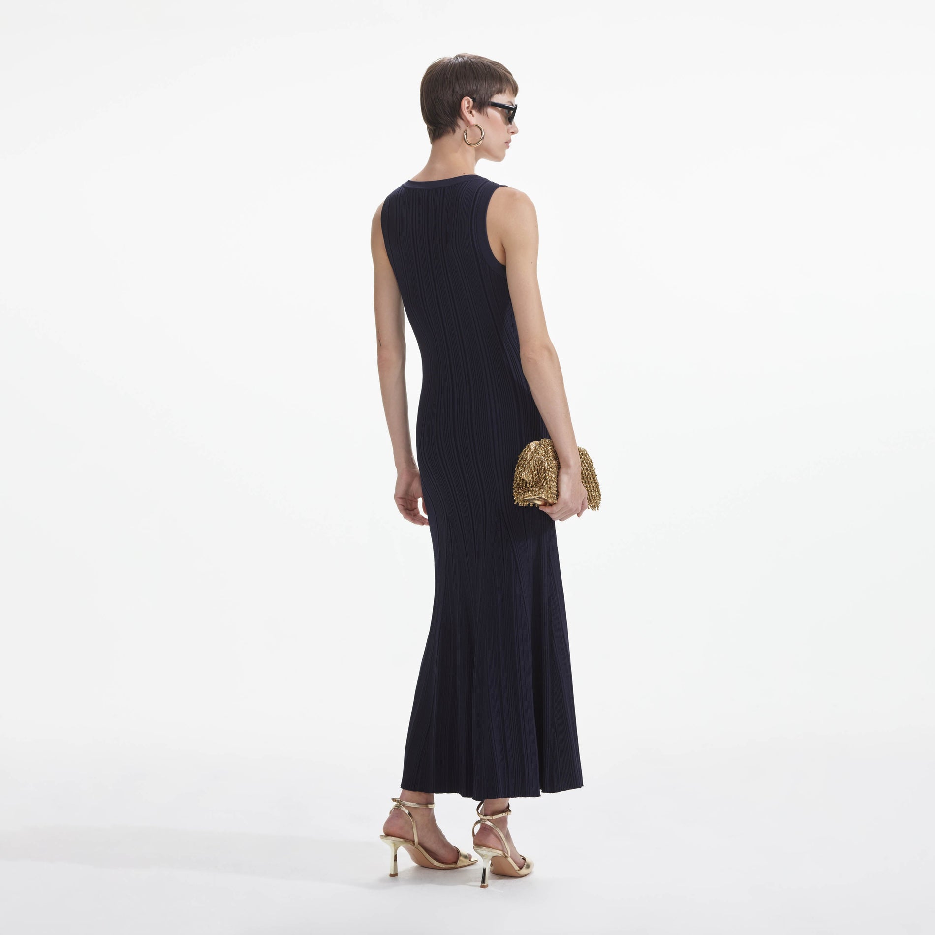 Back view of a woman wearing the Navy Viscose Knit Midi Dress