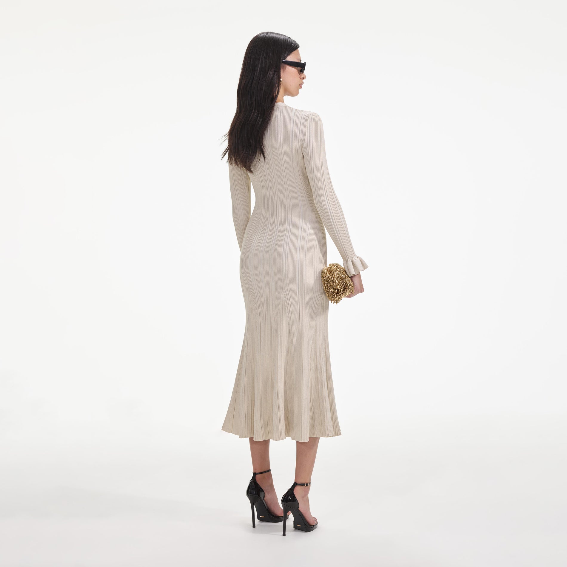 Back view of a woman wearing the Cream Metallic Ribbed Midi Dress