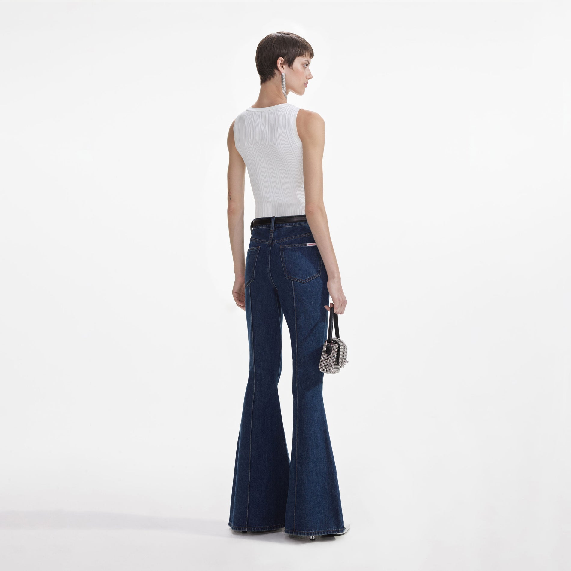 Back view of a woman wearing the White Ribbed Knit Top
