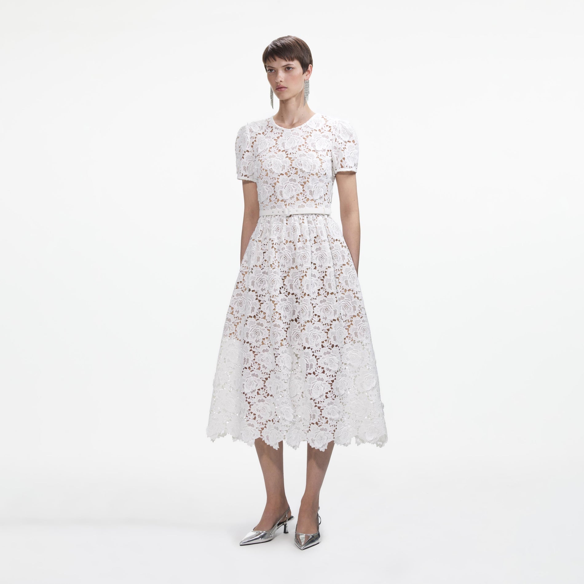 Side view of a woman wearing the White Floral Lace Midi Dress