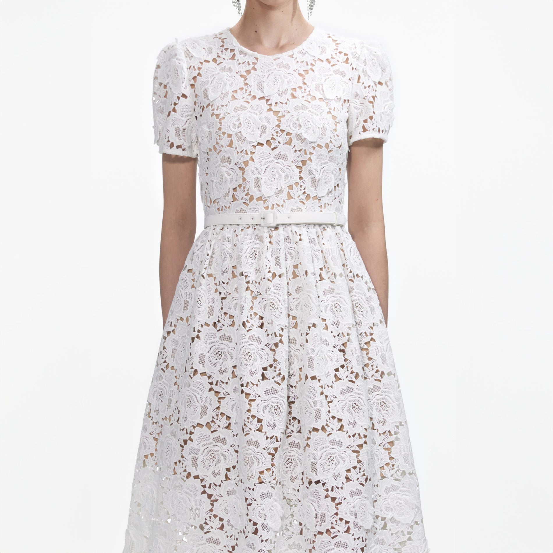 A close up of a woman wearing the White Floral Lace Midi Dress