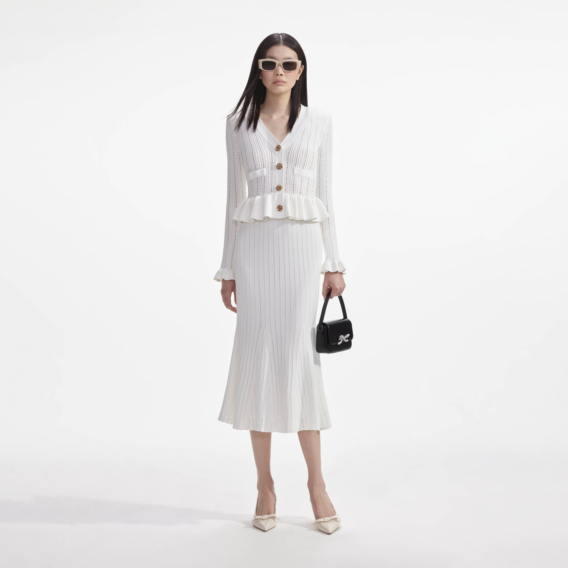 Front view of a woman wearing the White Knit Peplum Midi Dress