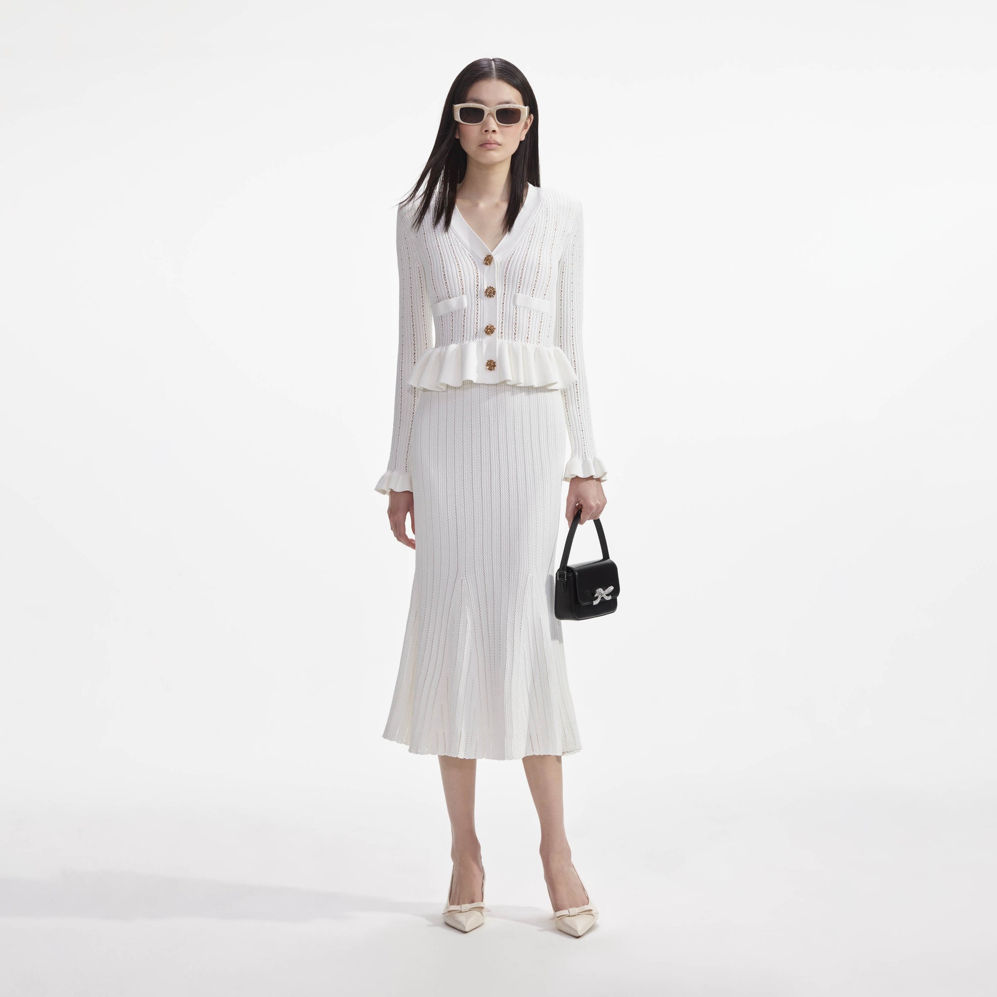 Front view of a woman wearing the White Knit Peplum Midi Dress