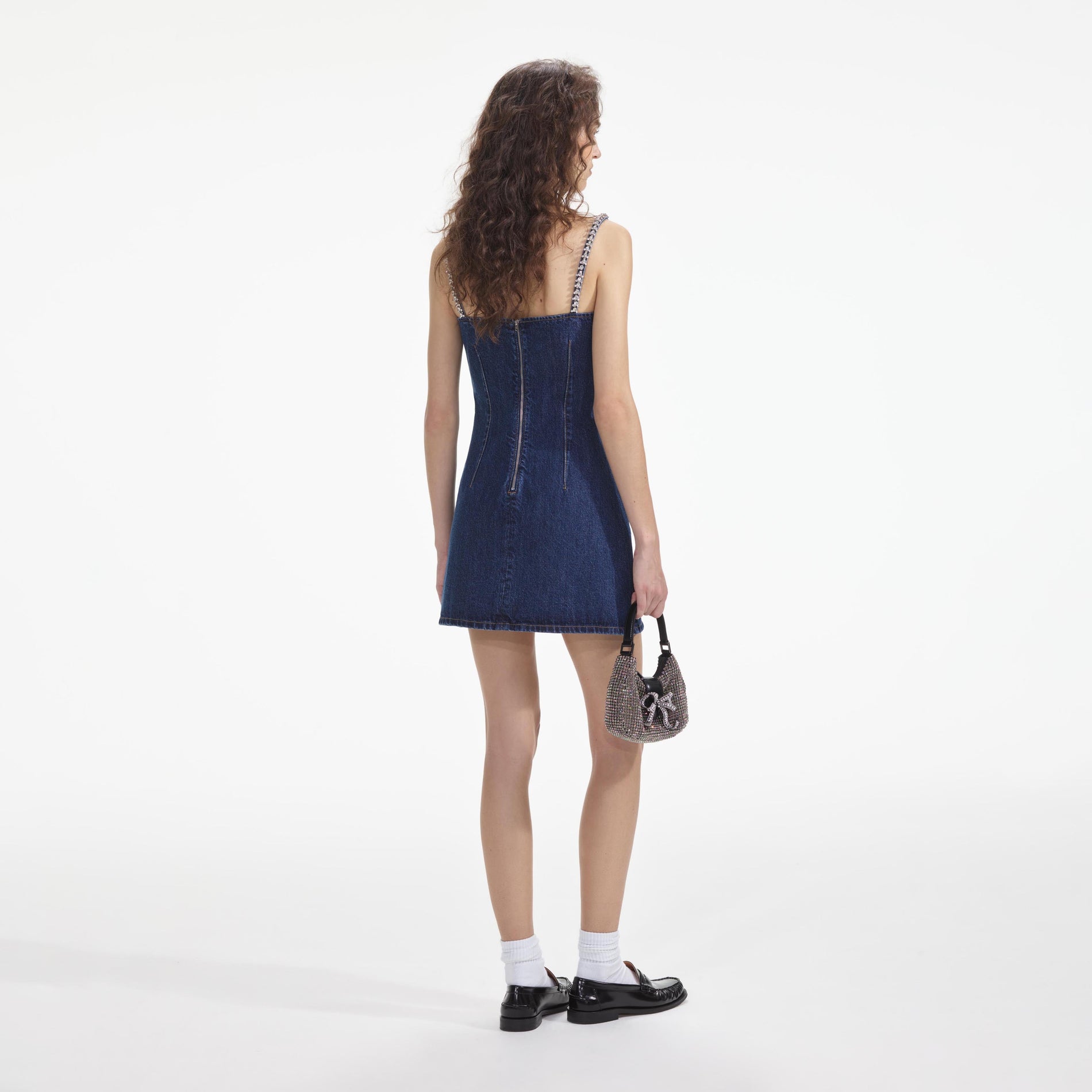 Back view of a woman wearing the Diamante Denim Mini Dress