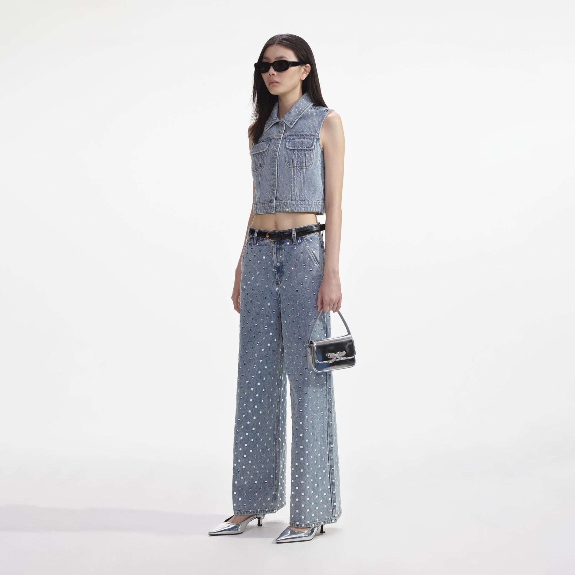 Side view of a woman wearing the Bleach Wash Rhinestone Denim Top