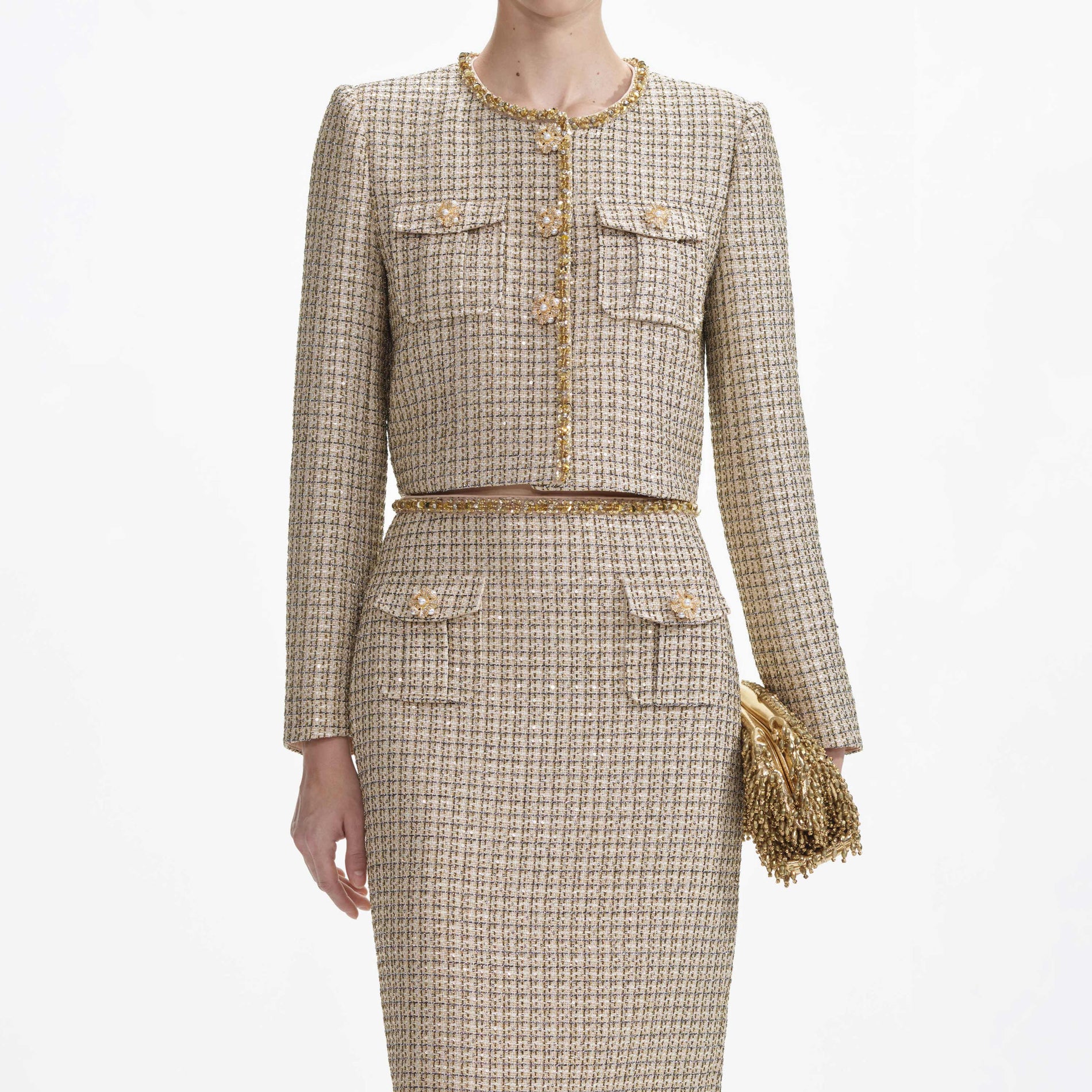 A close up of a woman wearing the Gold Boucle Midi Skirt