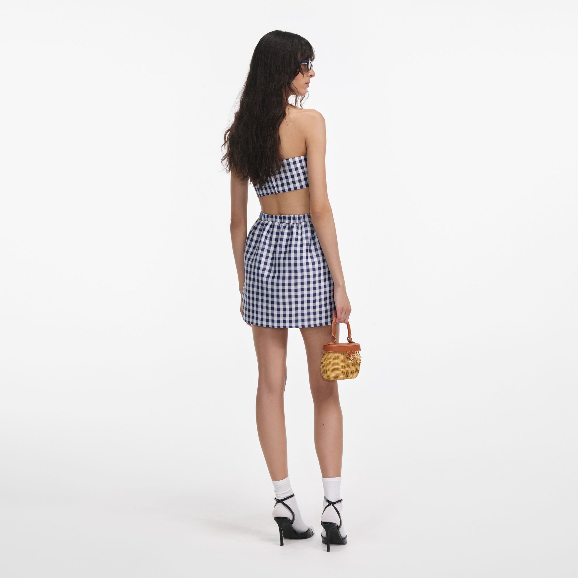Back view of a woman wearing the Navy Gingham Taffeta Mini Skirt