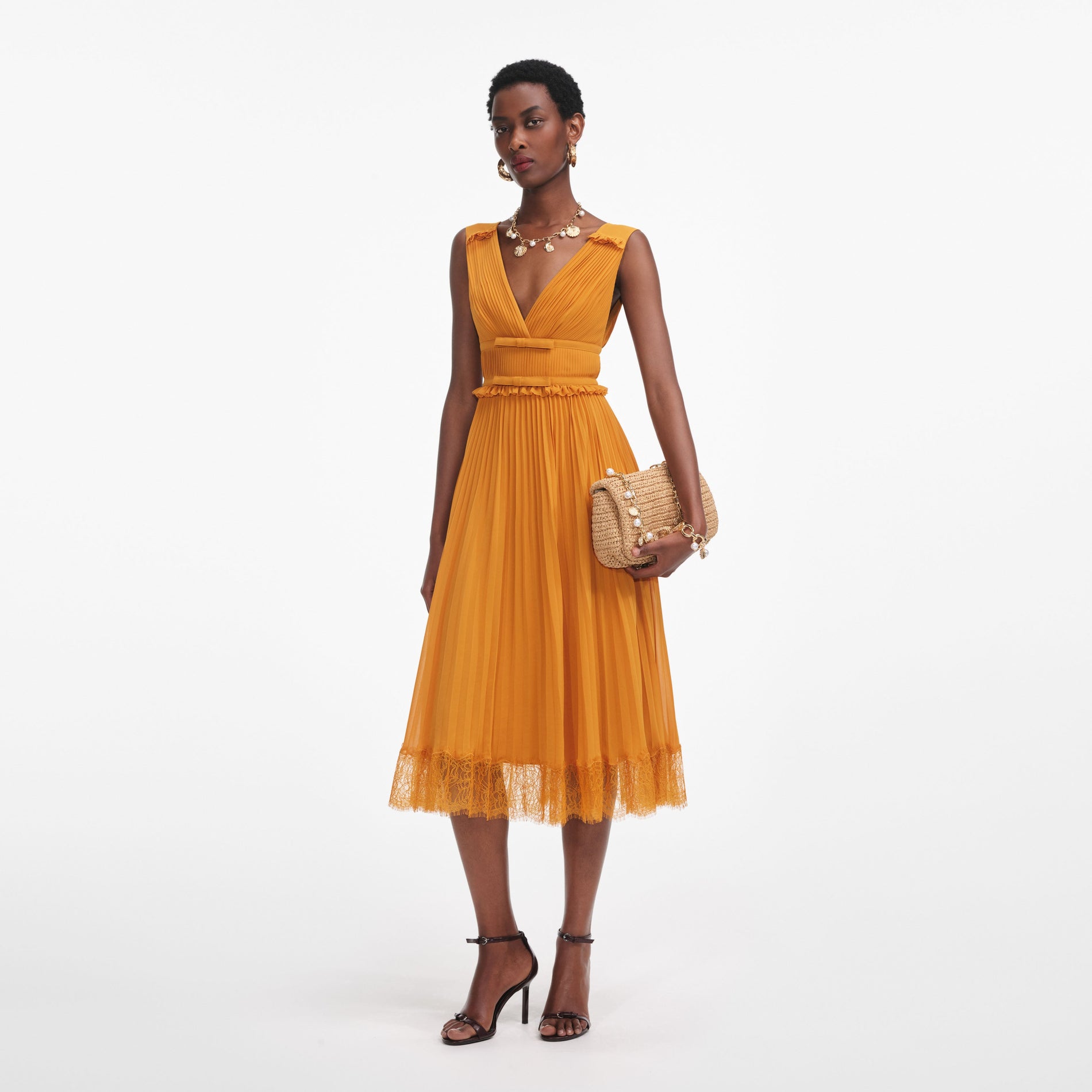 Side view of a woman wearing the Burnt Orange Chiffon Midi Dress