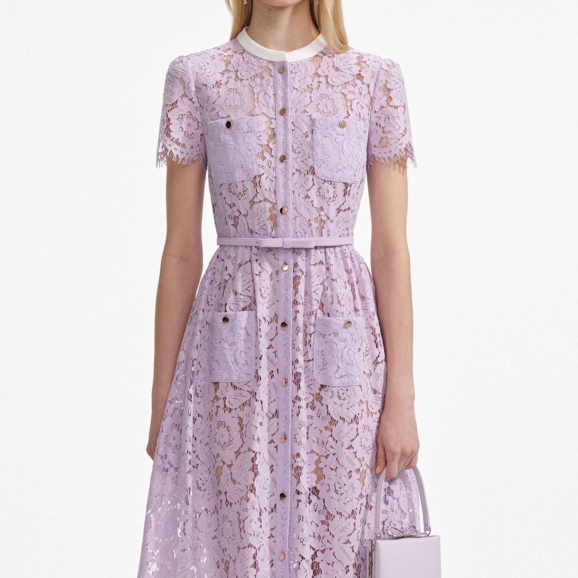 A close up of a woman wearing the Lilac Lace Button Front Midi Dress