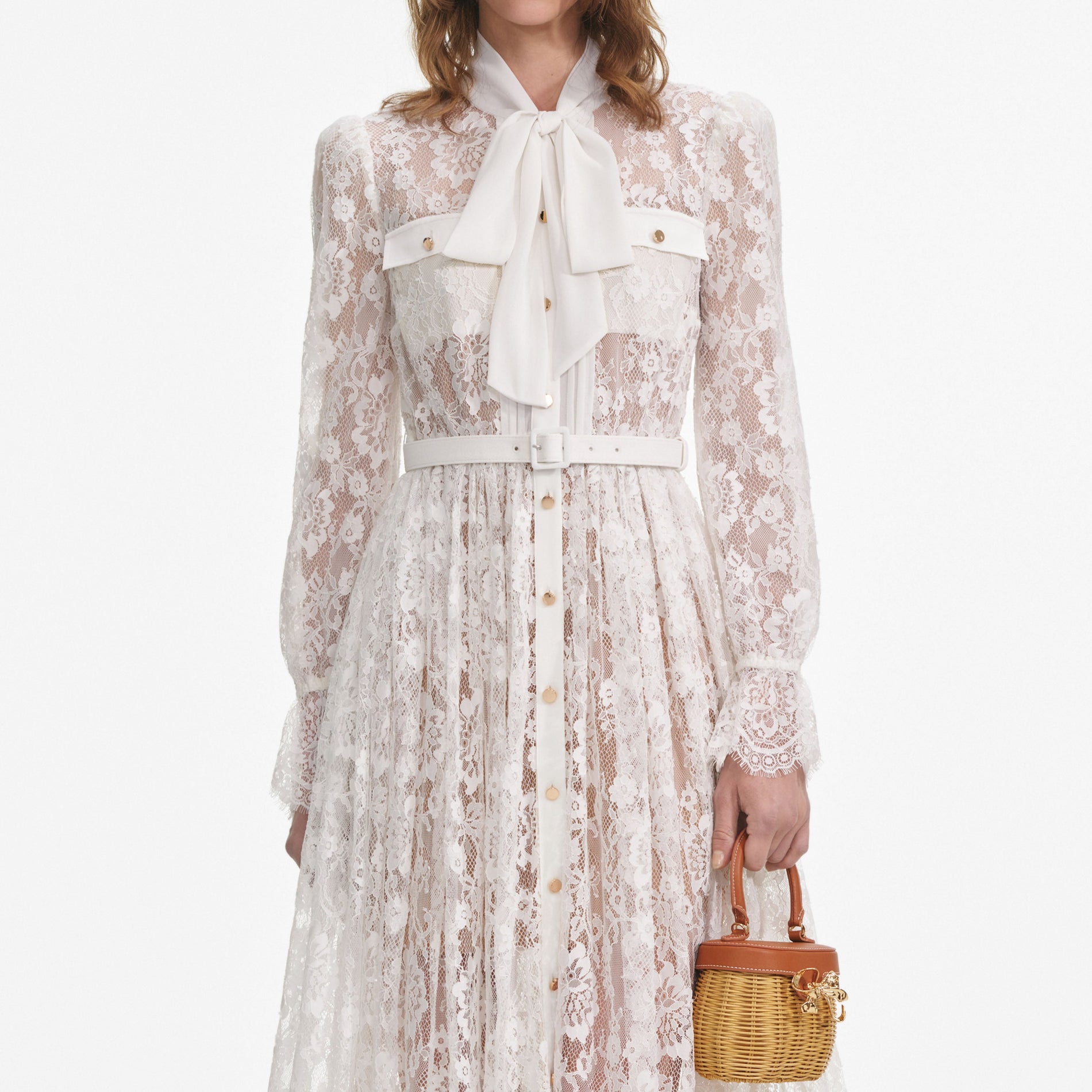 A close up of a woman wearing the White Lace Pussy Bow Midi Dress