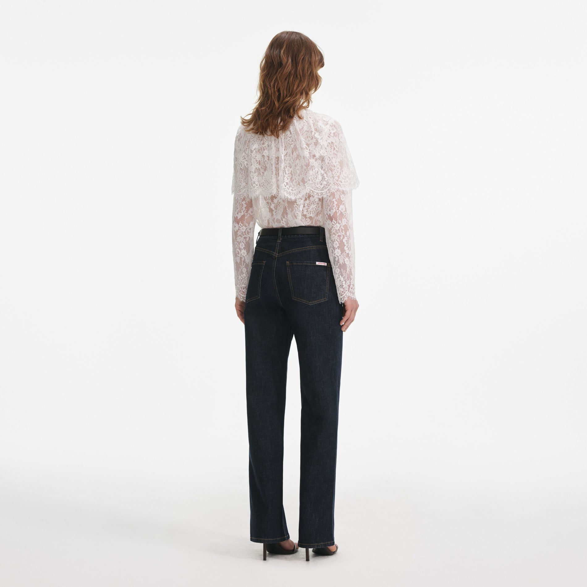 Back view of a woman wearing the White Lace Cape Top
