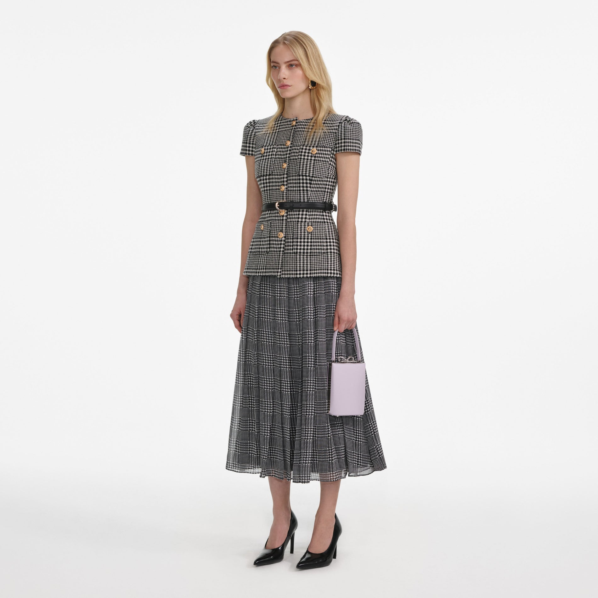 Side view of a woman wearing the Houndstooth Tailored Midi Dress