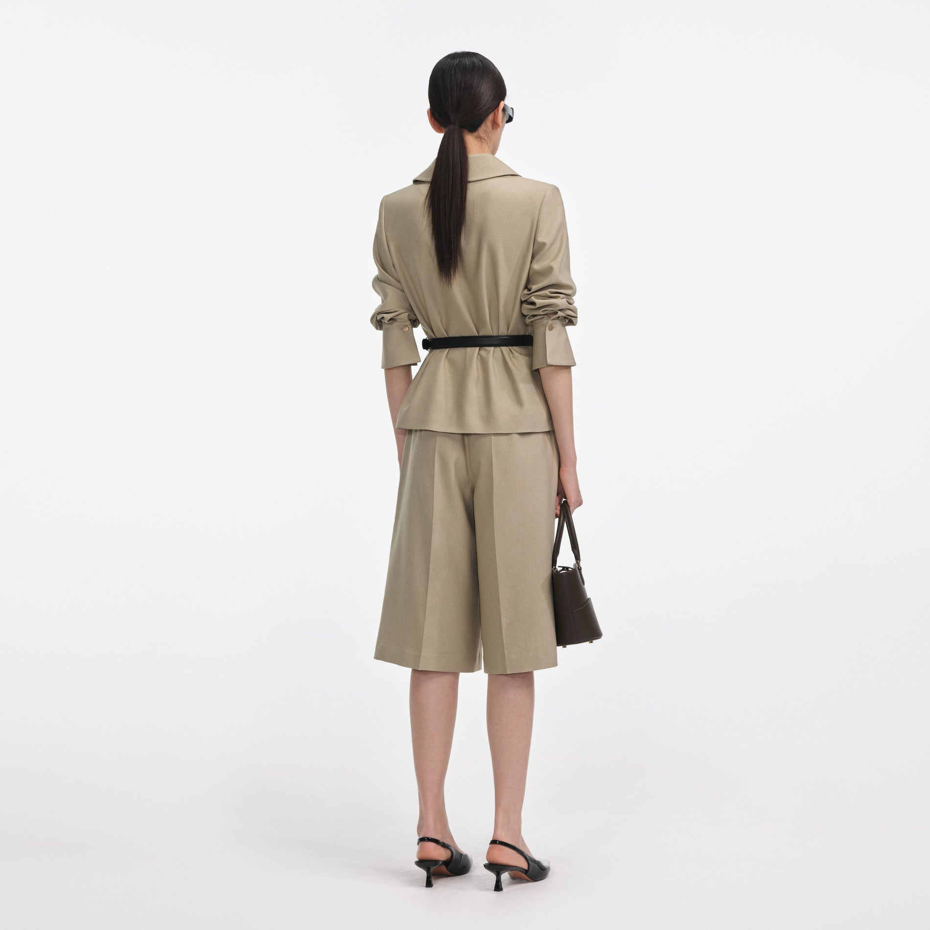 Back view of a woman wearing the Beige Twill Playsuit