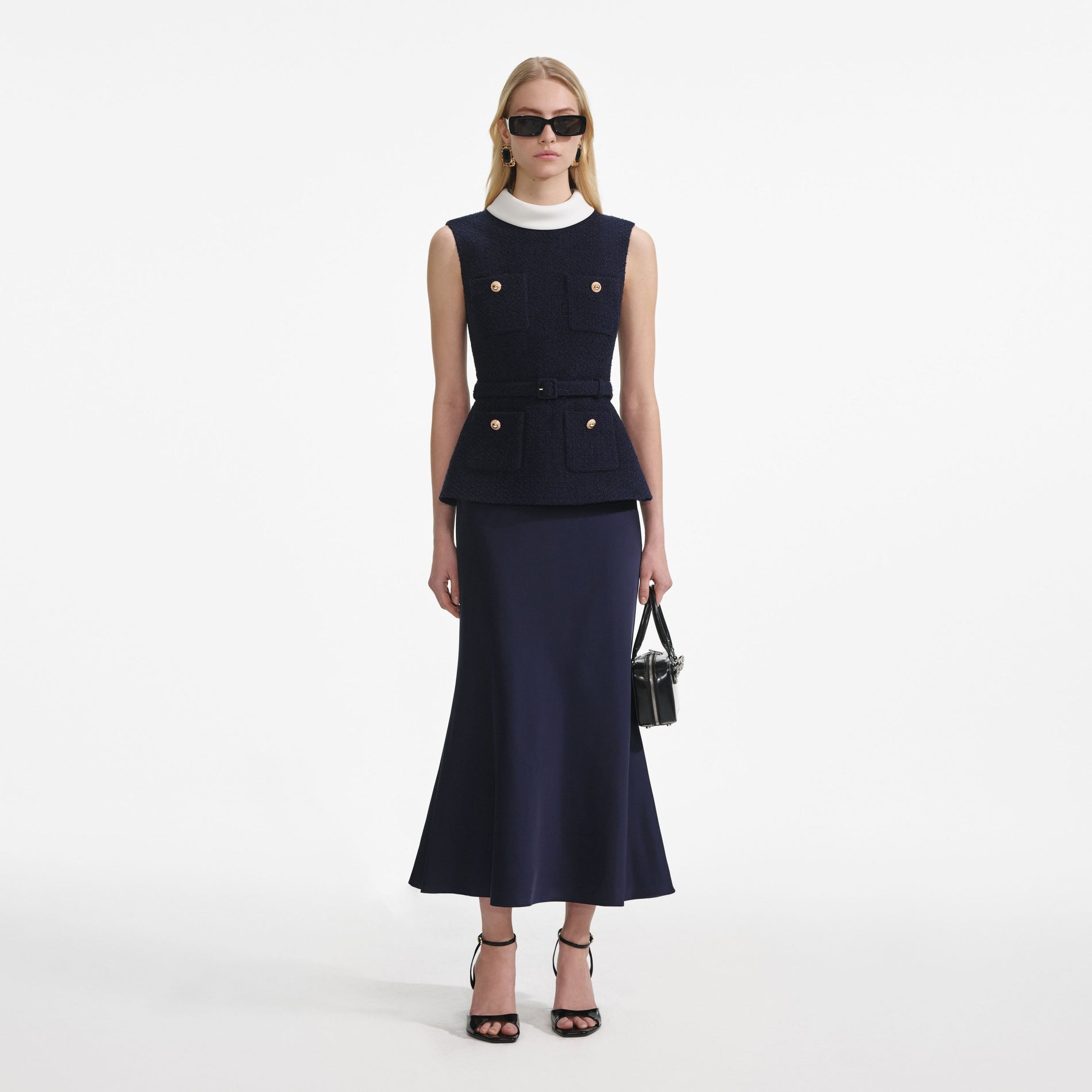 Front view of a woman wearing the Navy Boucle Sleeveless Midi Dress