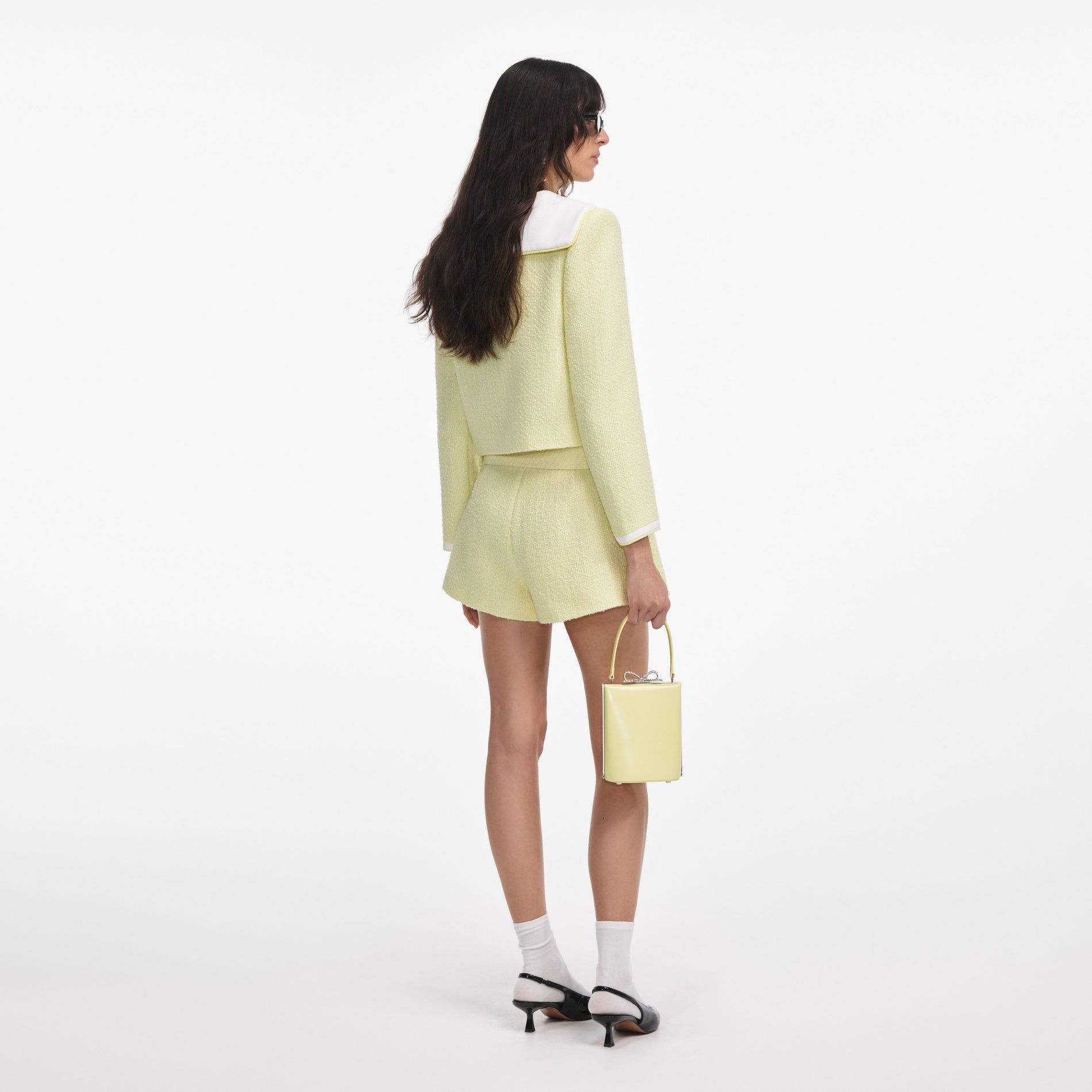 Back view of a woman wearing the Yellow Boucle Skort
