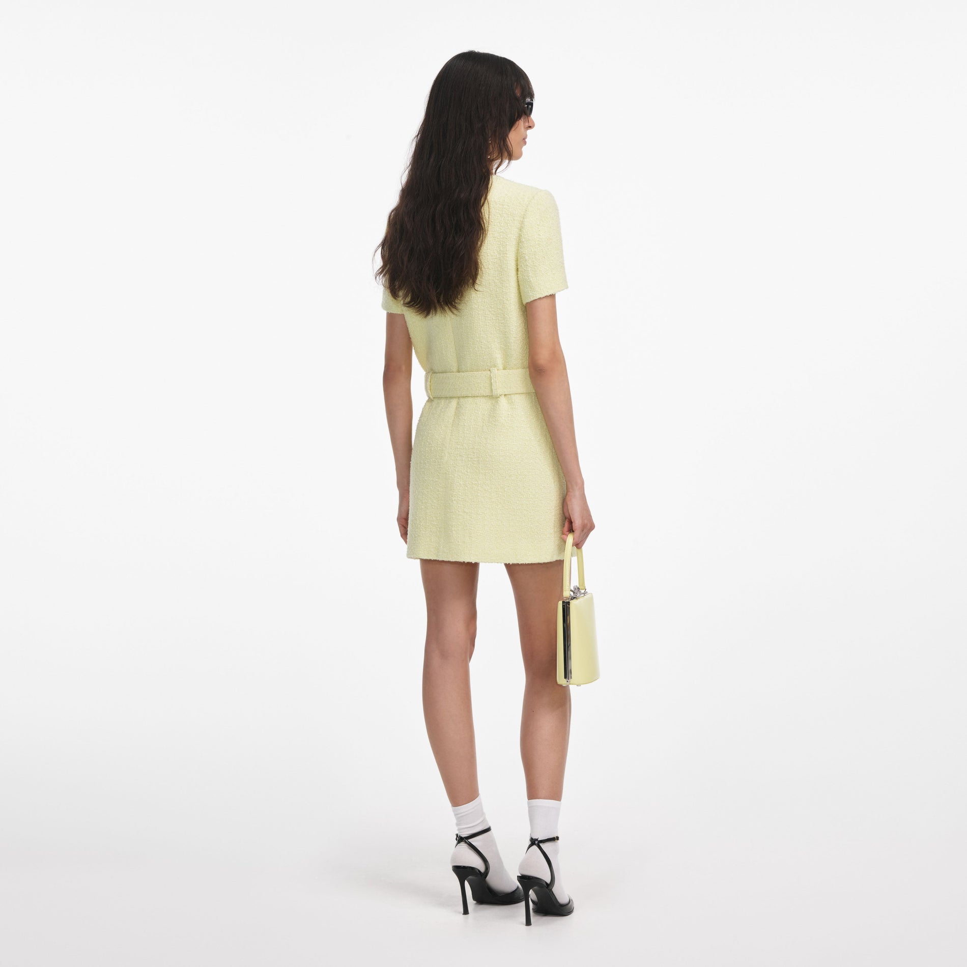 Back view of a woman wearing the Yellow Boucle Mini Dress