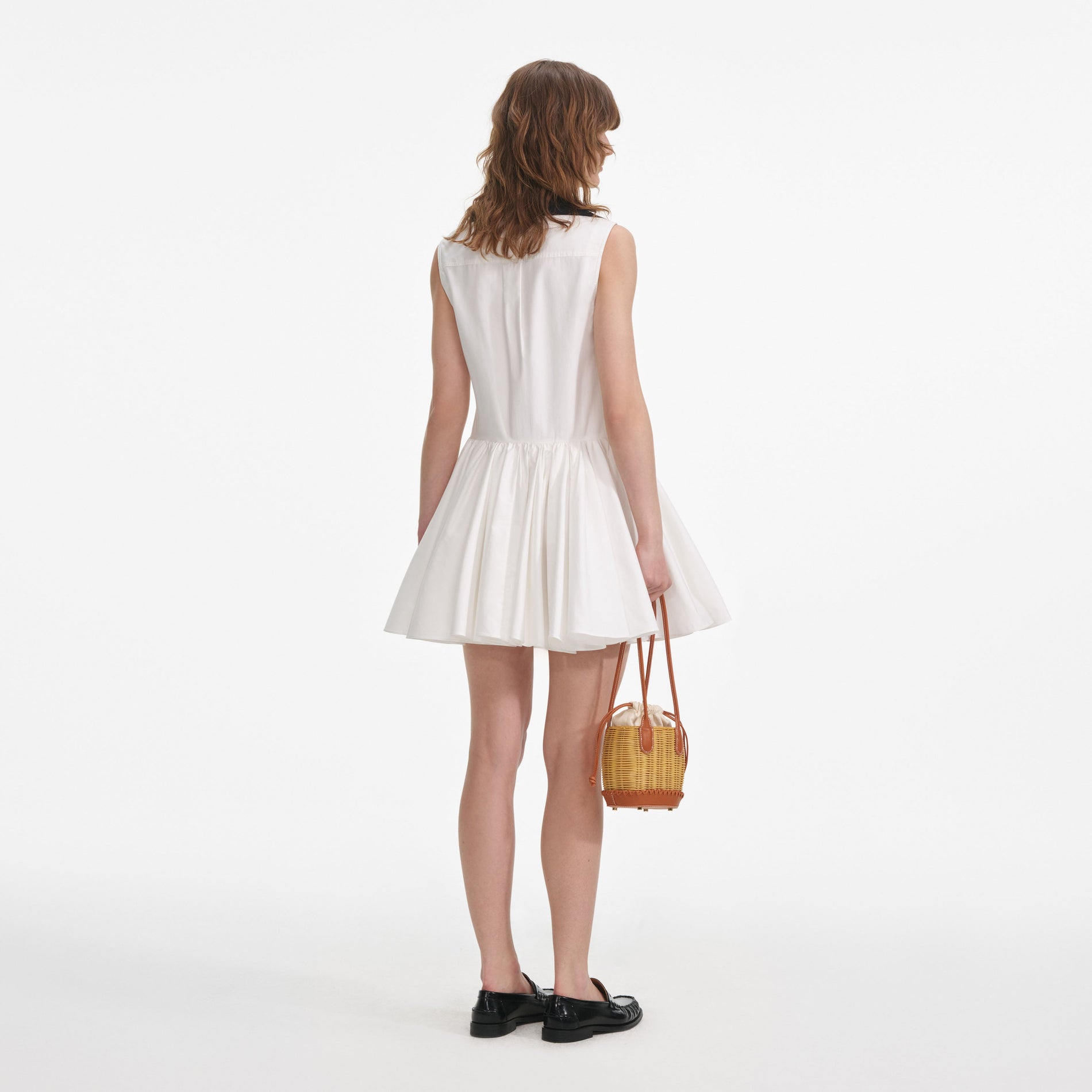 Back view of a woman wearing the White Cotton Contrast Collar Mini Dress