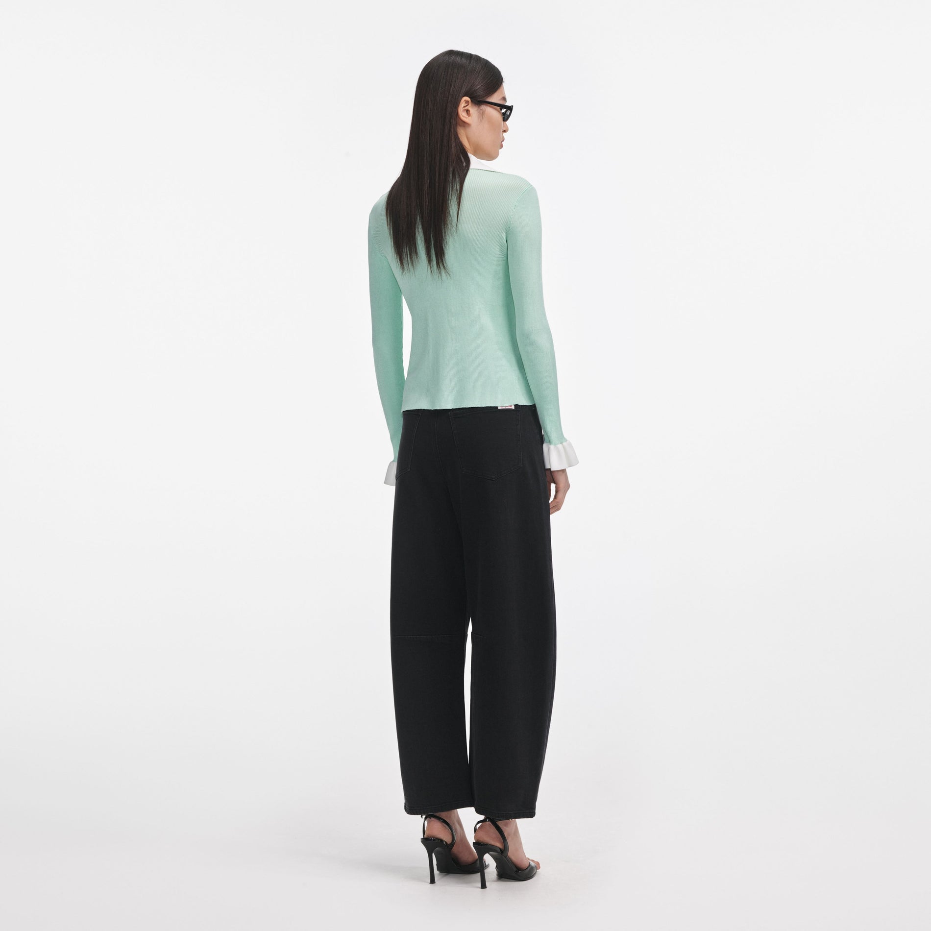 Back view of a woman wearing the Green Ribbed Viscose Knit Top