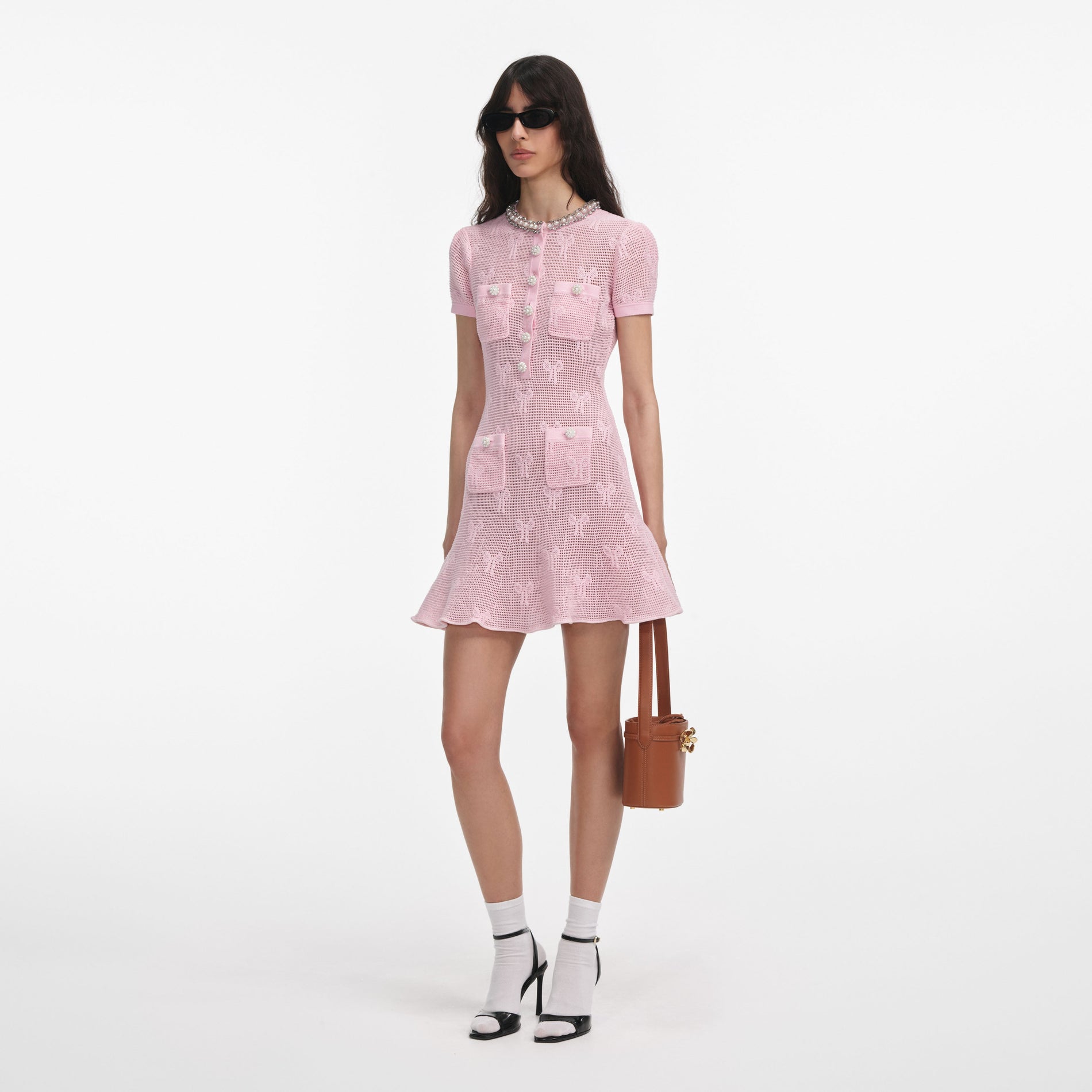 Side view of a woman wearing the Pink Bow Crochet Crystal Trim Mini Dress
