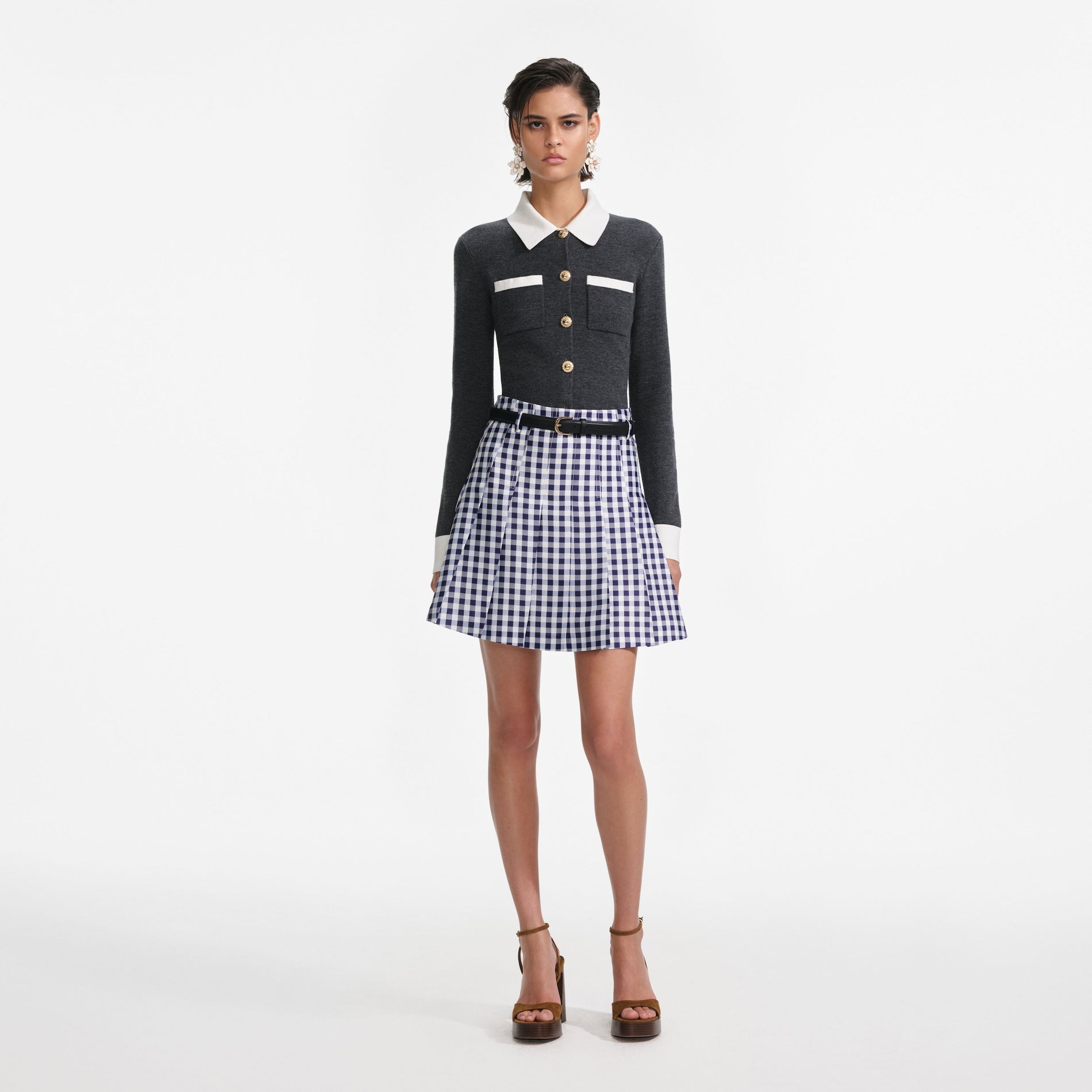 Front view of a woman wearing the Navy Gingham Pleated Taffeta Mini Skirt
