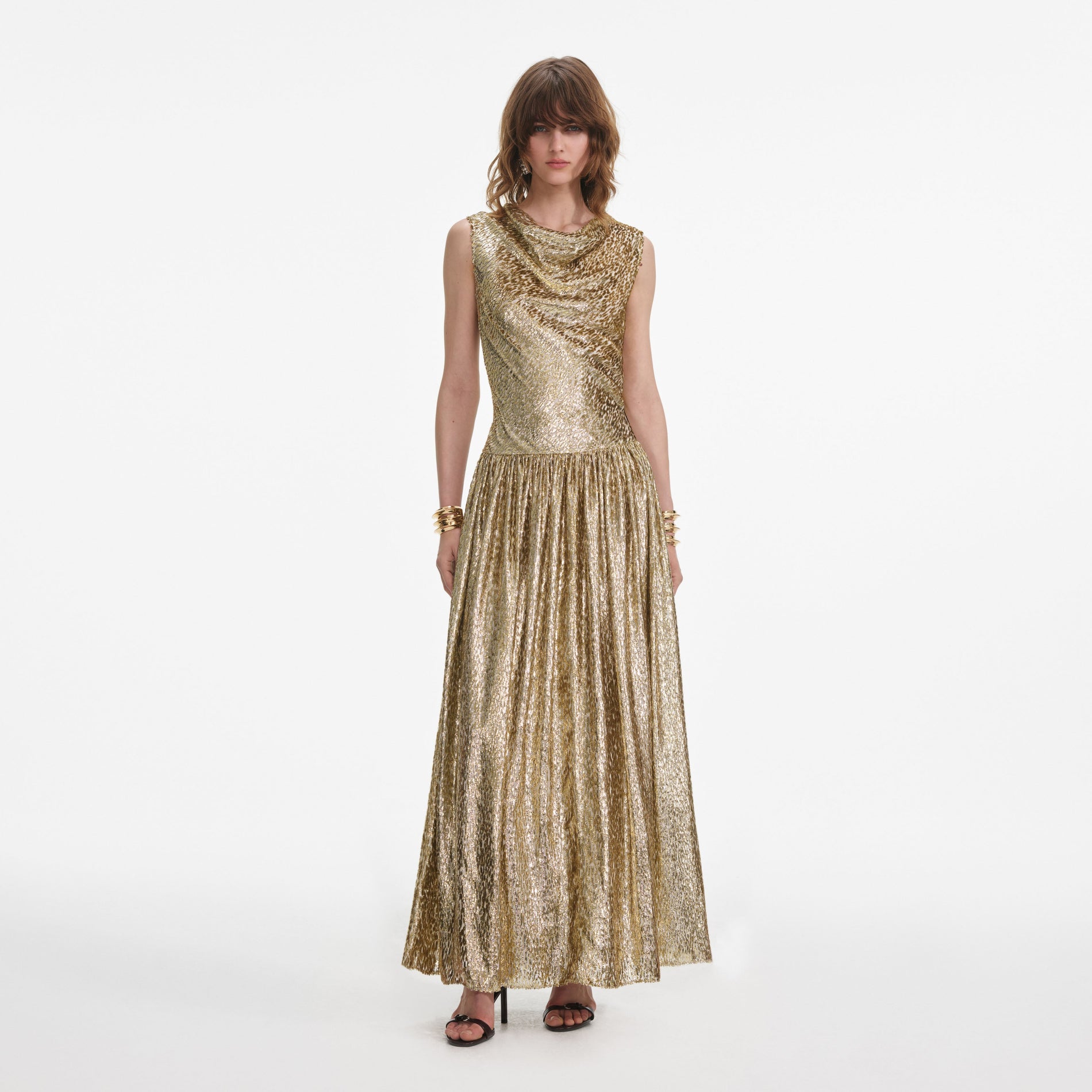 Front view of a woman wearing the Gold Sleeveless Fil Coupe Maxi Dress