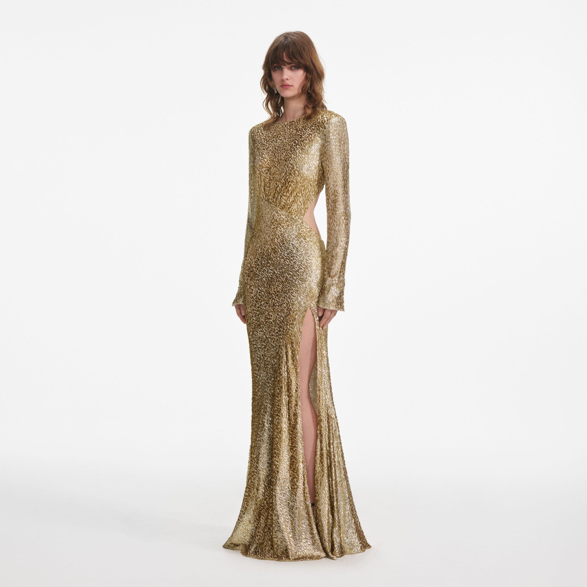 Side view of a woman wearing the Gold Fil Coupe Maxi Dress
