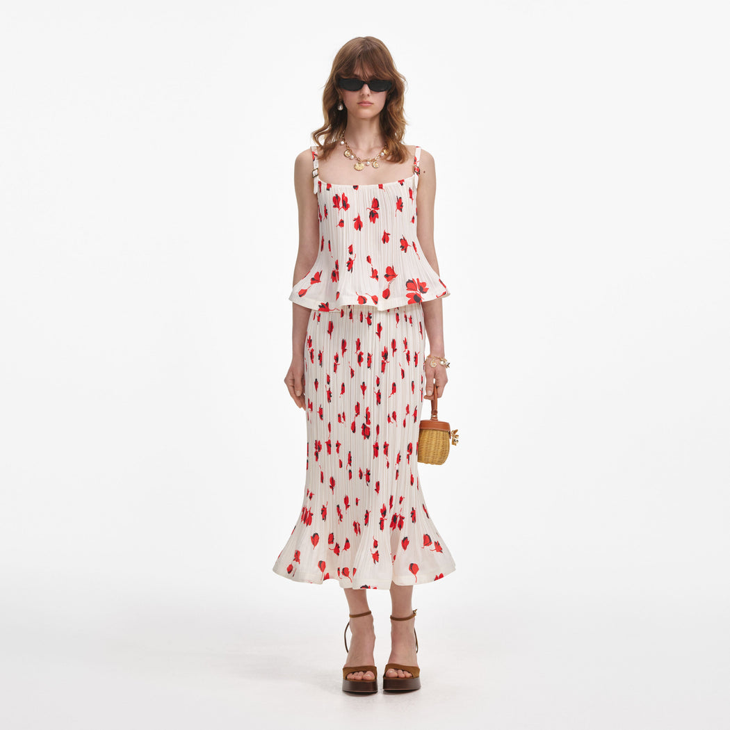 Front view of a woman wearing the White Floral Plisse Midi Skirt