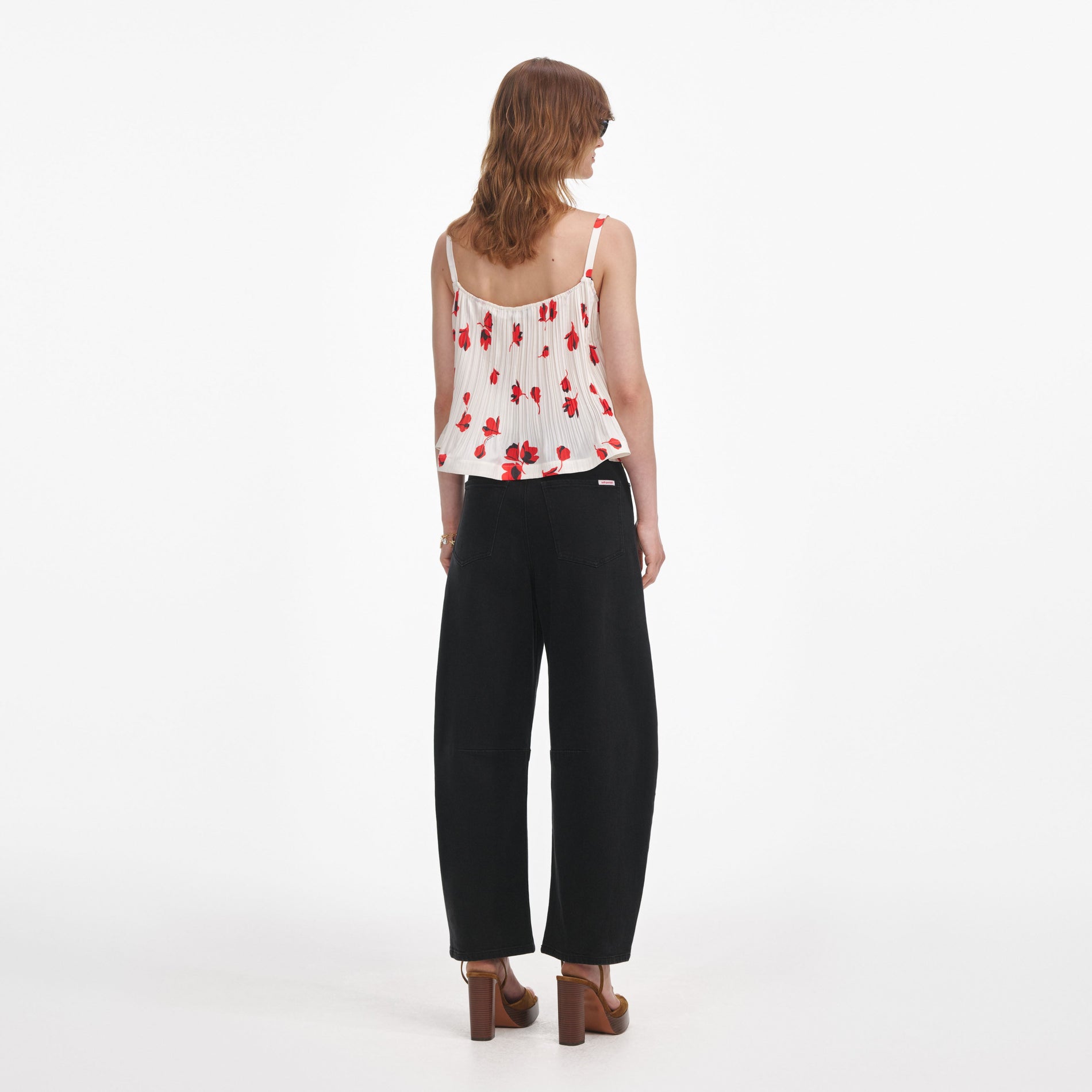 Back view of a woman wearing the White Floral Plisse Top