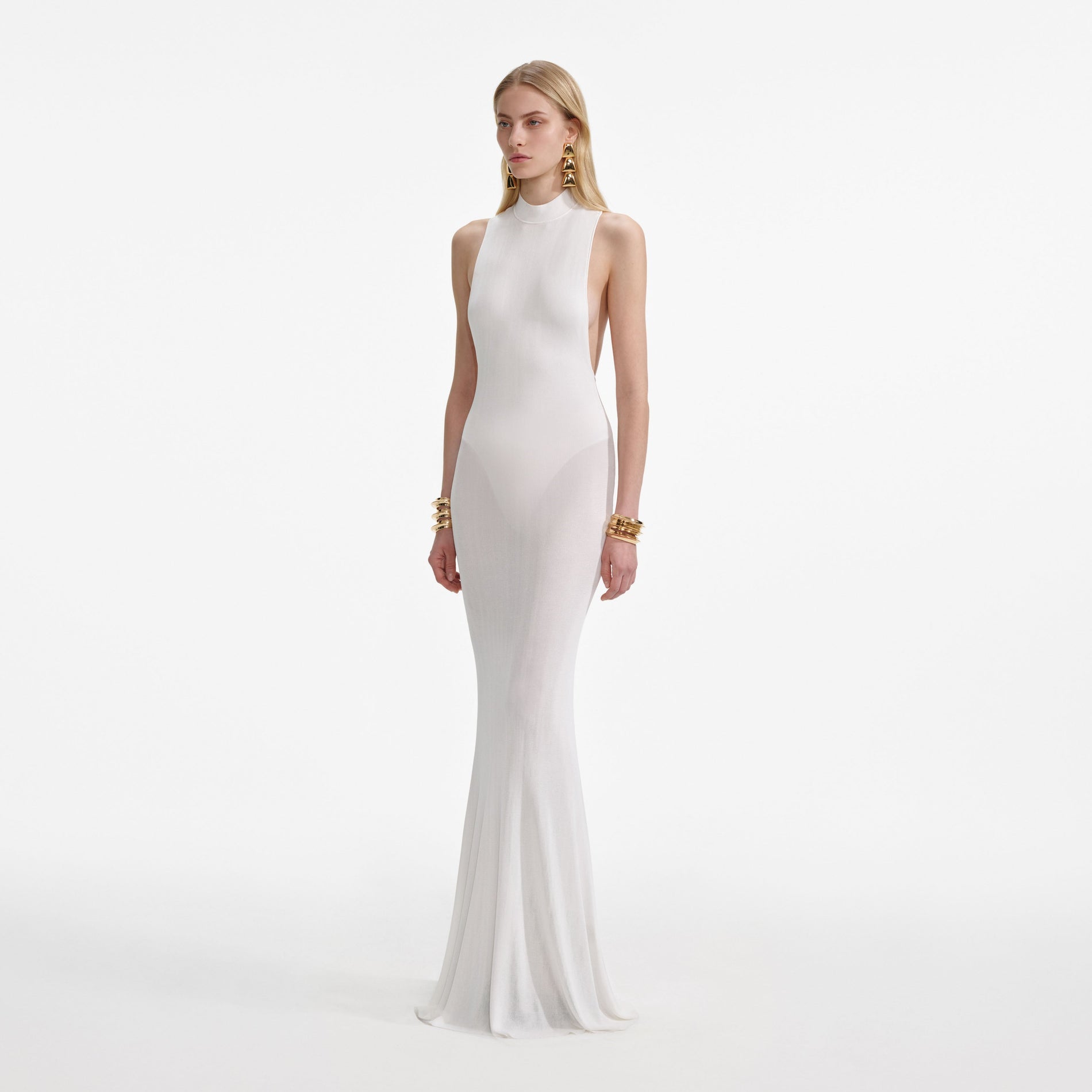 Side view of a woman wearing the White Racer Back Viscose Knit Maxi Dress