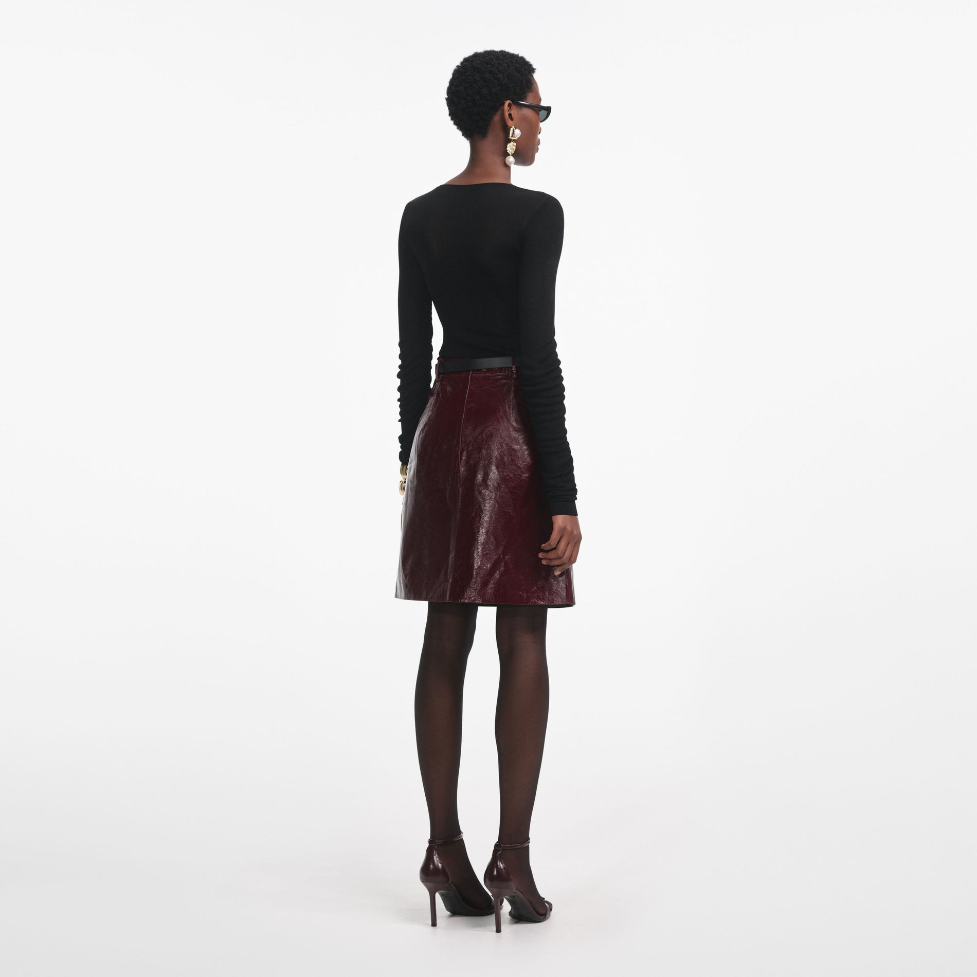 Back view of a woman wearing the Black Viscose Knit Top