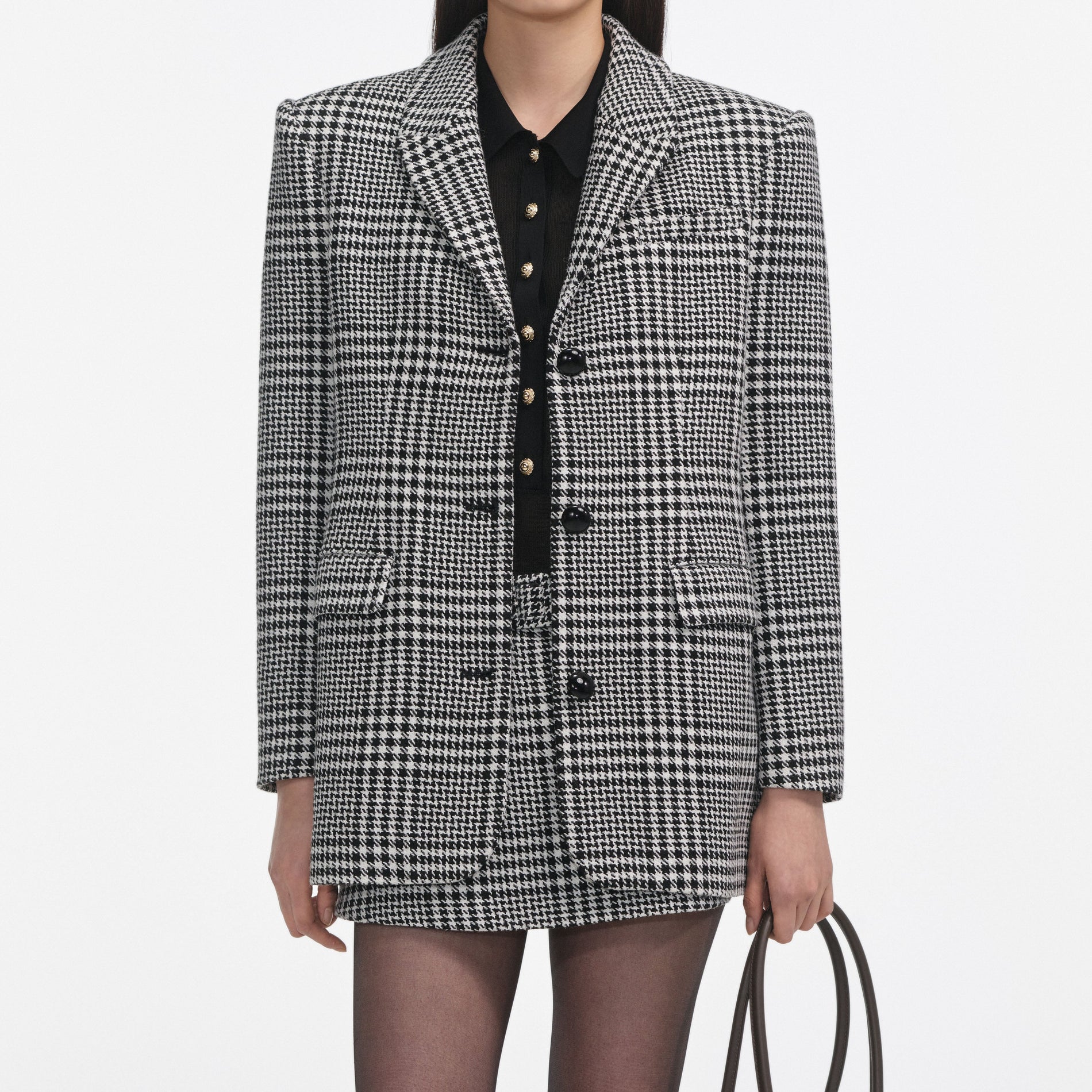 A close up of a woman wearing the Houndstooth Blazer